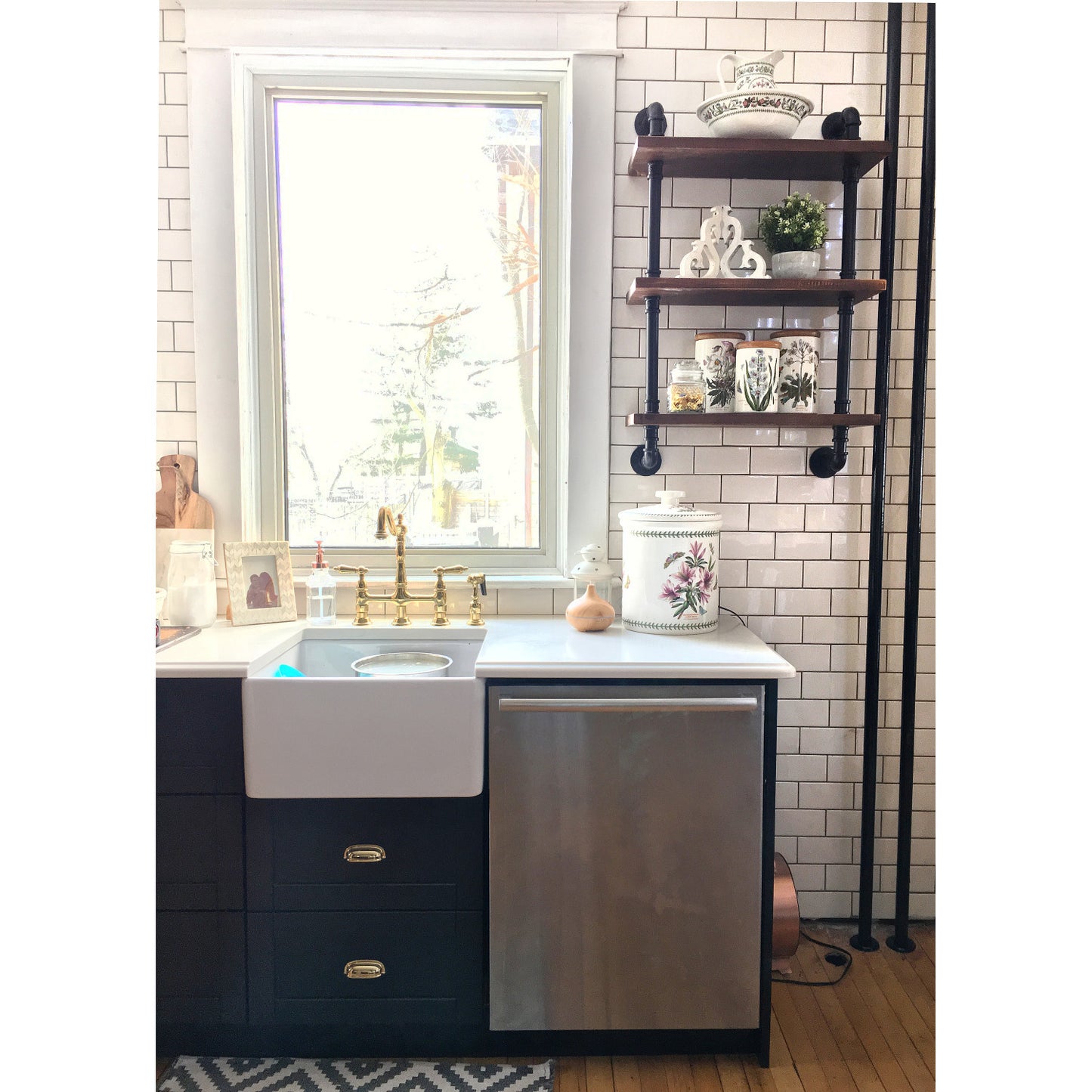KINGSTON Brass Heritage Bridge Kitchen Faucet with Brass Sprayer displayed in a stylish kitchen sink area.
