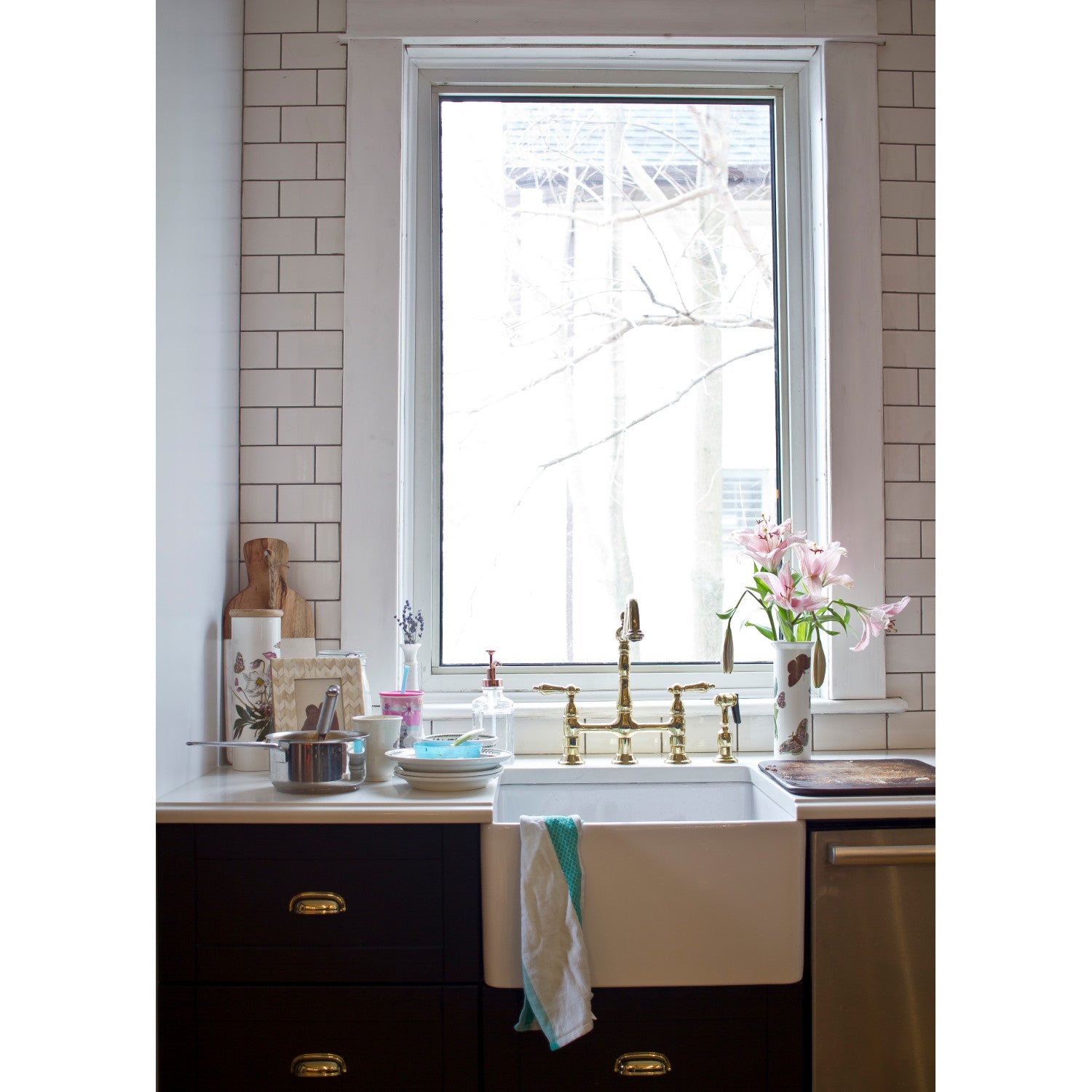 Tiny kitchen with white farmhouse sink, window, and Kingston Brass KS1272ALBS polished brass faucet