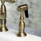 Kingston Brass KS1273ALBS antique brass kitchen faucet with close up of spray head on a white countertop