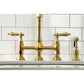 Kingston Brass KS1277ALBS brushed brass faucet set against a white tiled wall