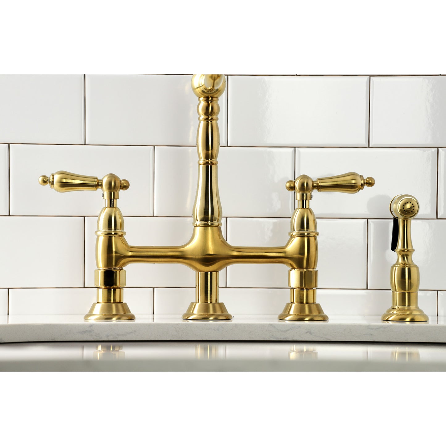 Front view of the KINGSTON Brass Heritage Bridge Kitchen Faucet with Brass Sprayer on a white tiled backsplash.