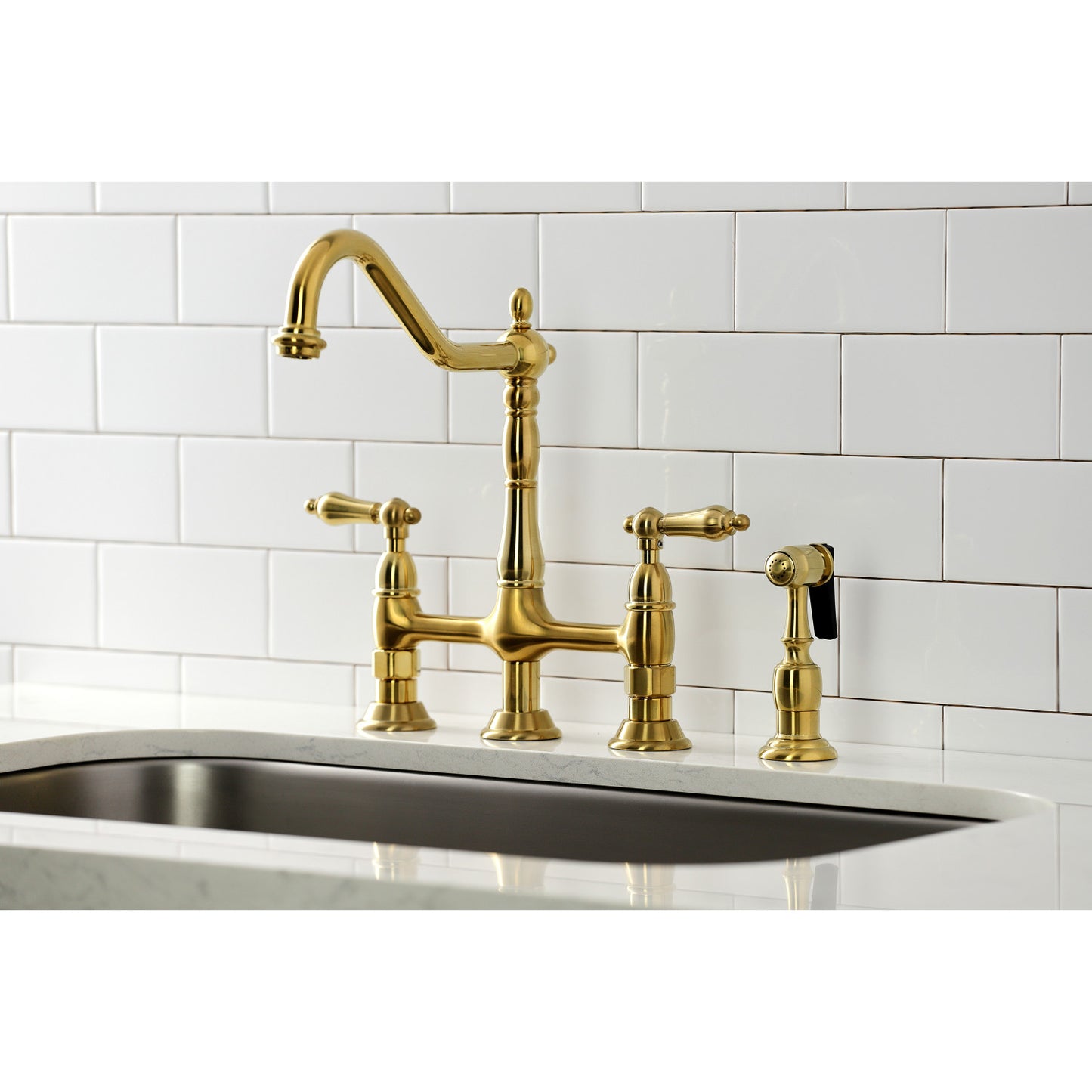 Kingston Brass KS1277ALBS brushed brass kitchen faucet with white tiled wall in the background