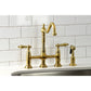Kingston Brass KS1277ALBS brushed brass kitchen faucet installed in quartz countertop against a white tiled wall