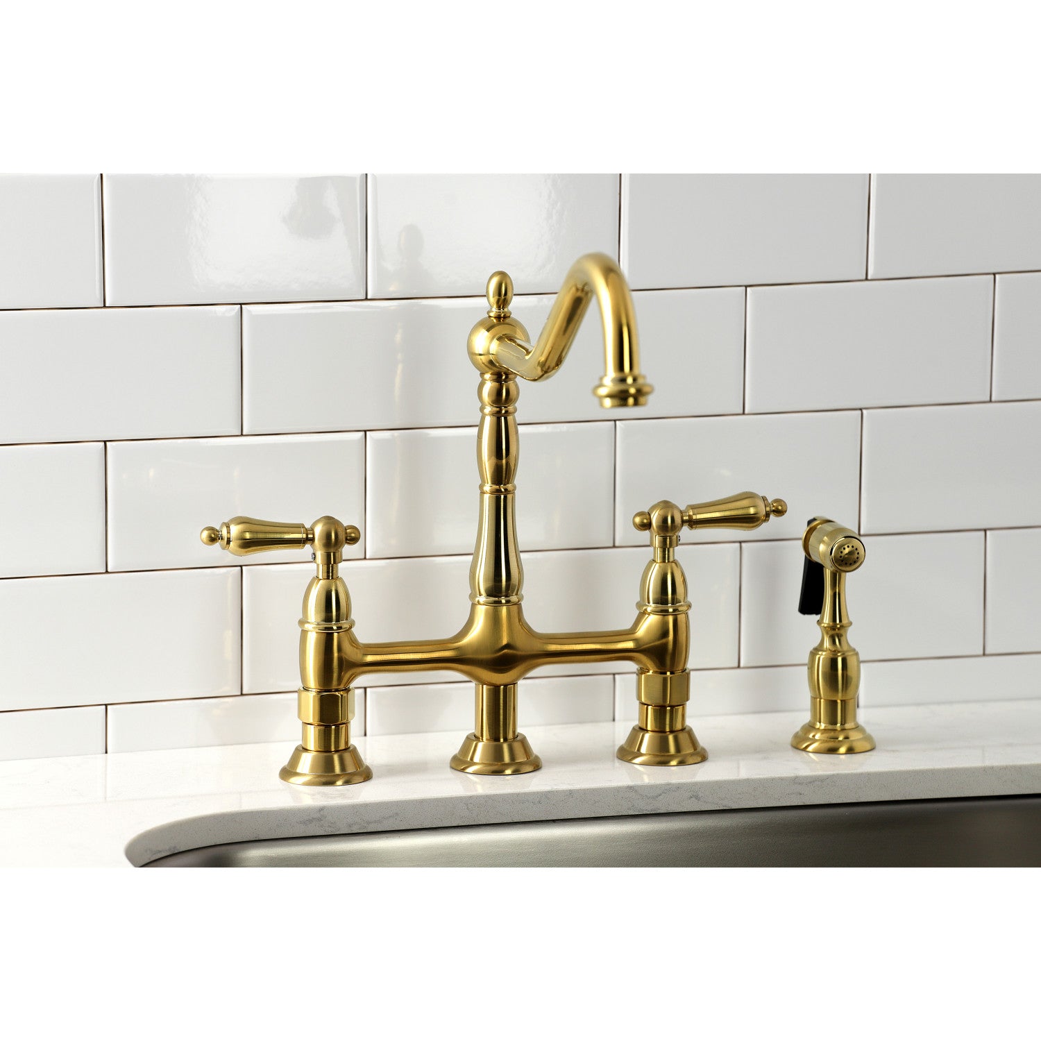 Kingston Brass KS1277ALBS brushed brass kitchen faucet installed in quartz countertop against a white tiled wall