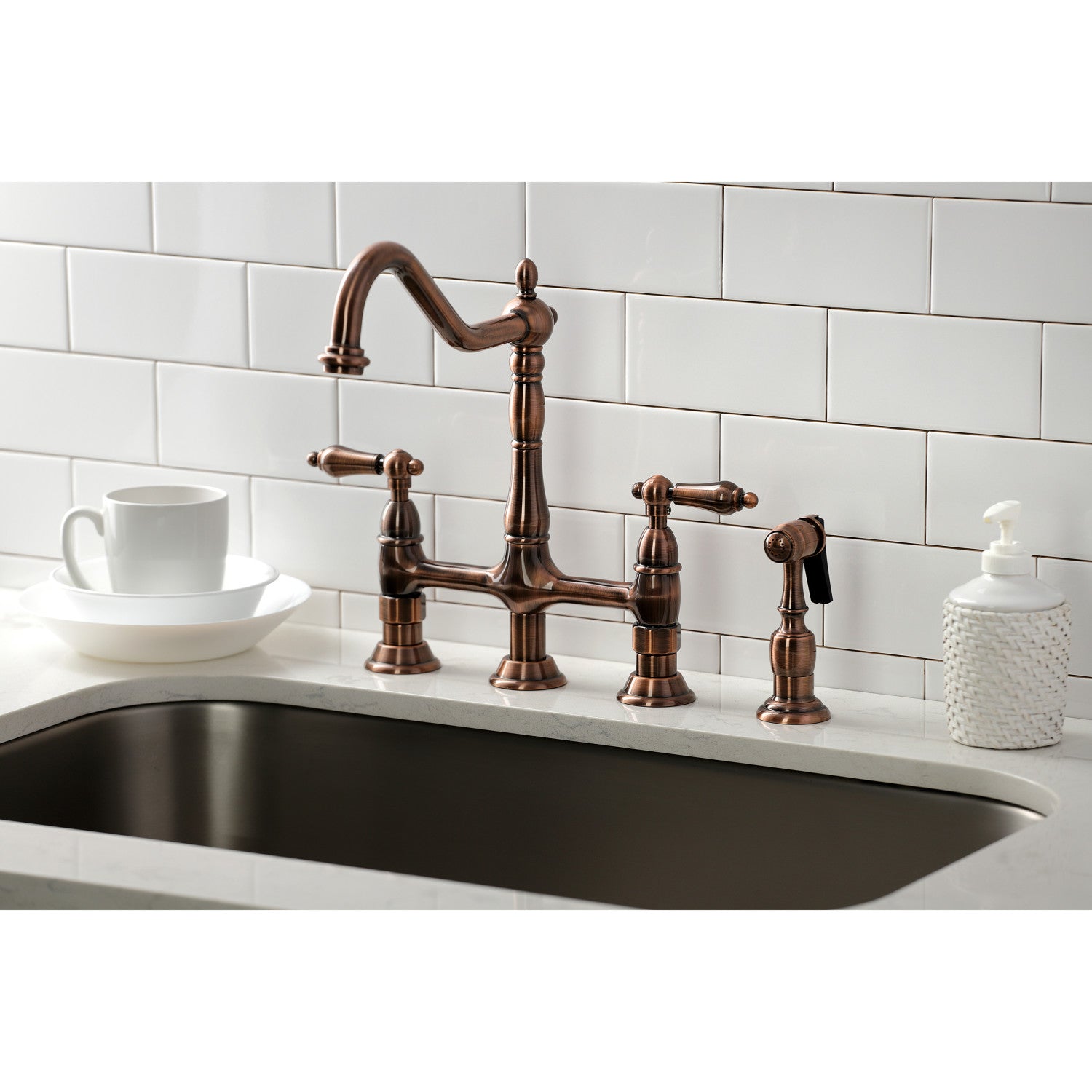 Kingston Brass KS127ALBSAC antique copper kitchen faucet with side spray installed in a white quartz countertop
