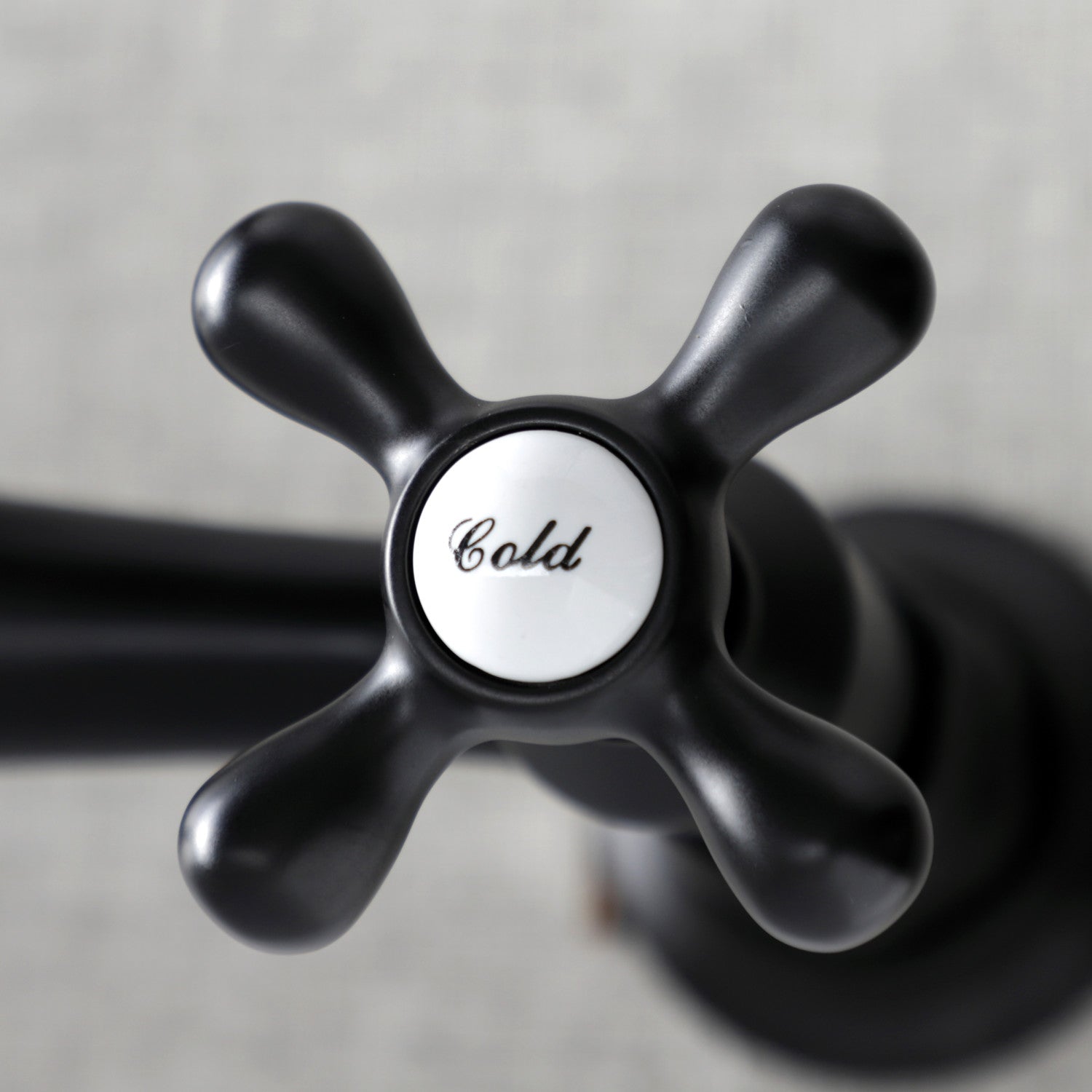 Kingston Brass KS3240AX matte black bathroom faucet handle with 'Cold' label on a neutral background