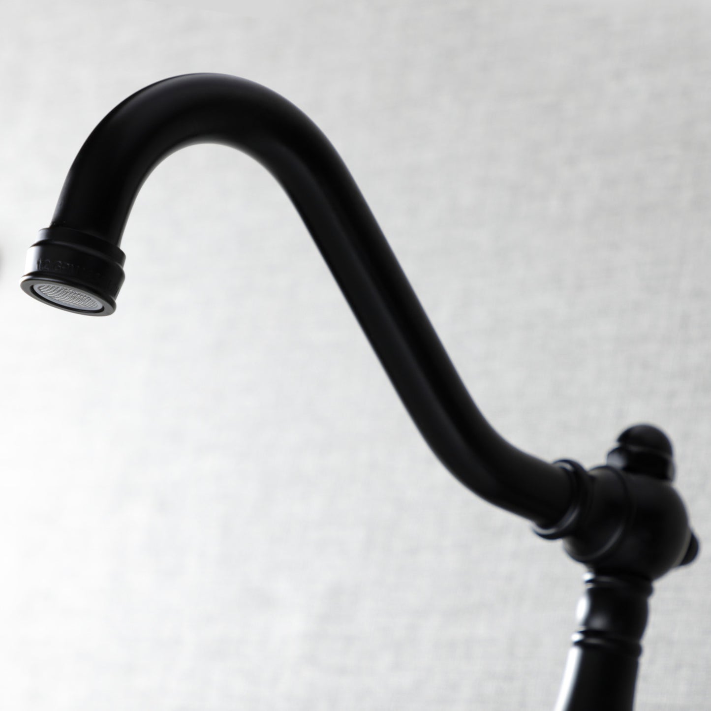KINGSTON Brass Vintage Wall Mount Bathroom Faucet - KS3245AX close-up view of faucet spout with ornate detailing