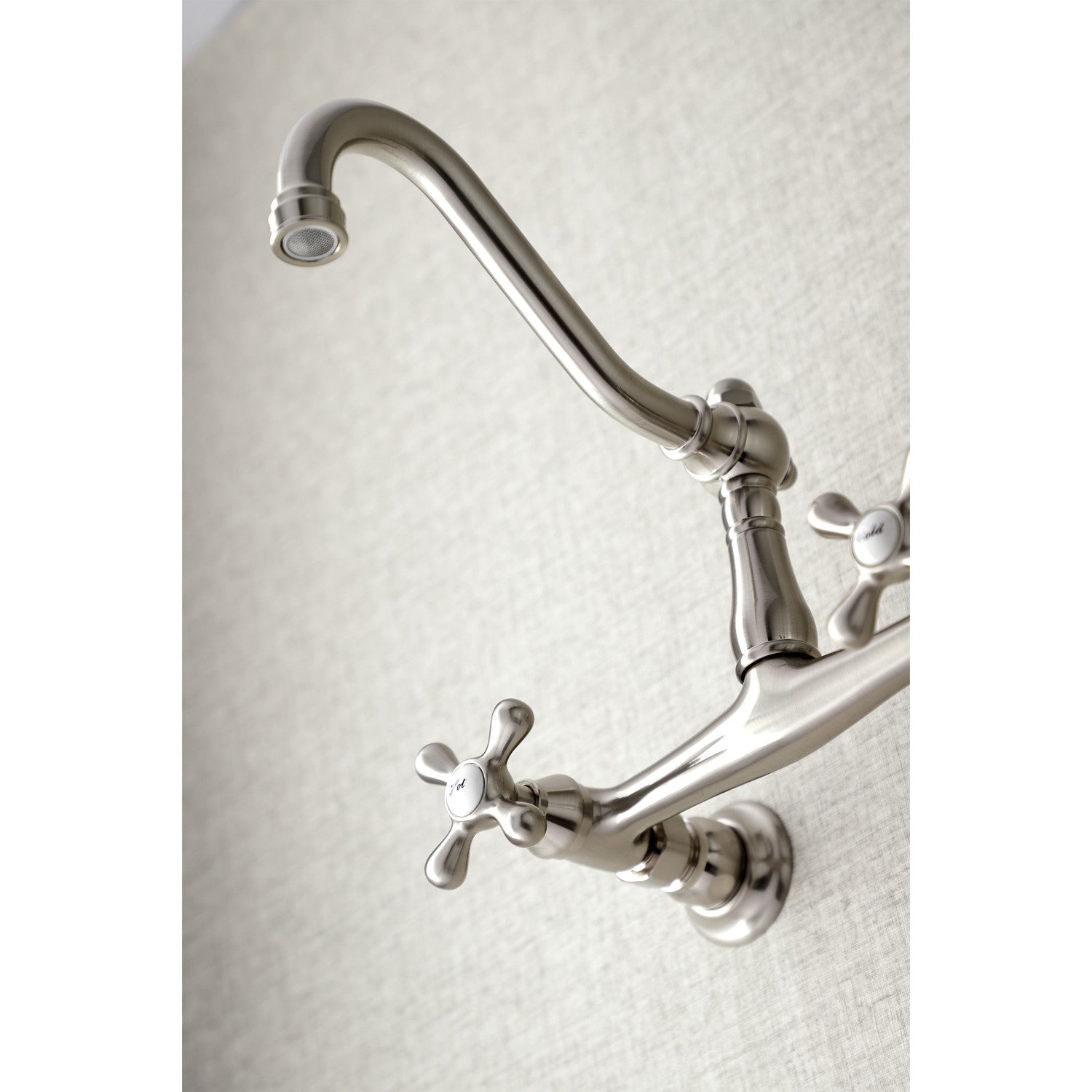 Kingston Brass KS3248AX brushed nickel  bathroom faucet mounted on a textured white background