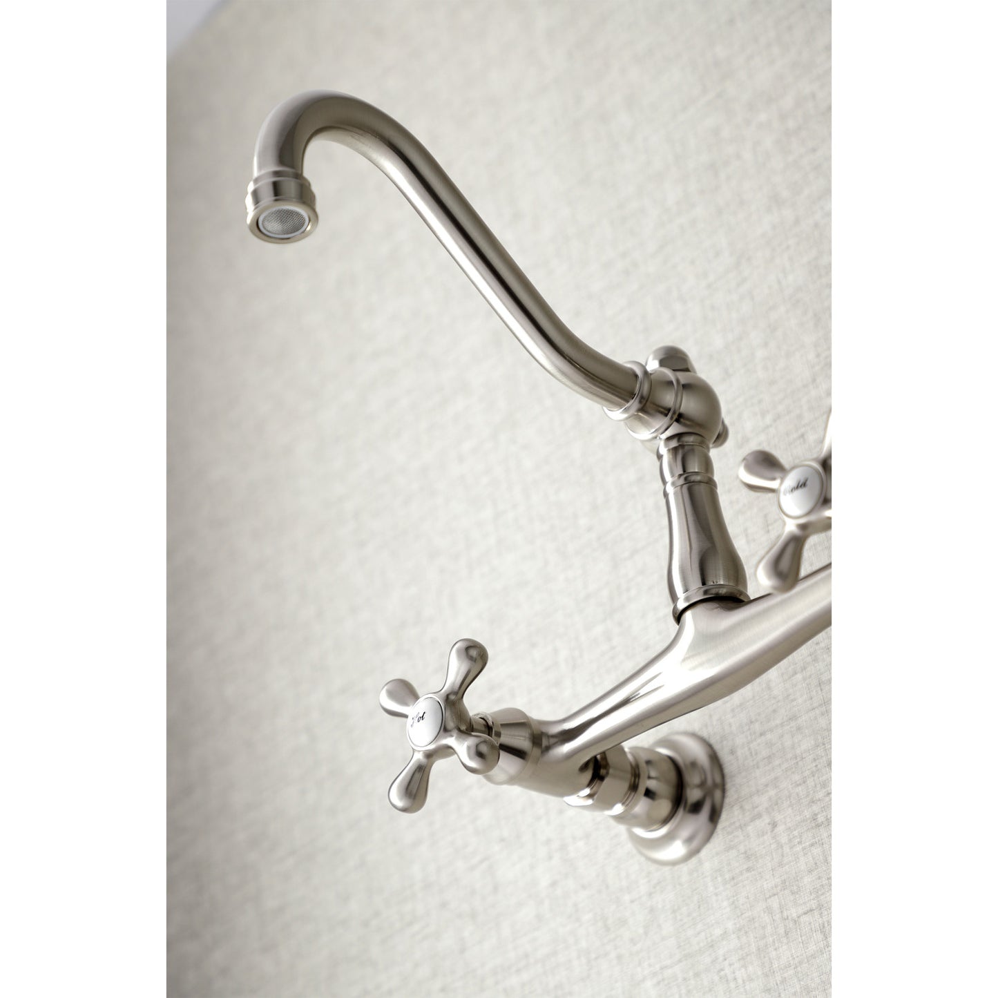 Kingston Brass KS3248AX brushed nickel  bathroom faucet mounted on a textured white background