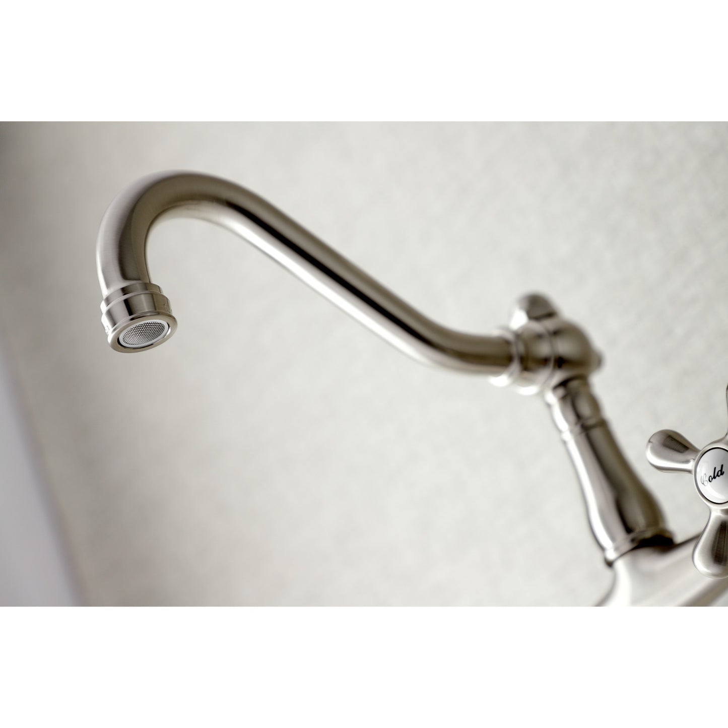 Close-up of KINGSTON Brass Vintage Wall Mount Bathroom Faucet - KS3245AX spout showcasing elegant design and craftsmanship.