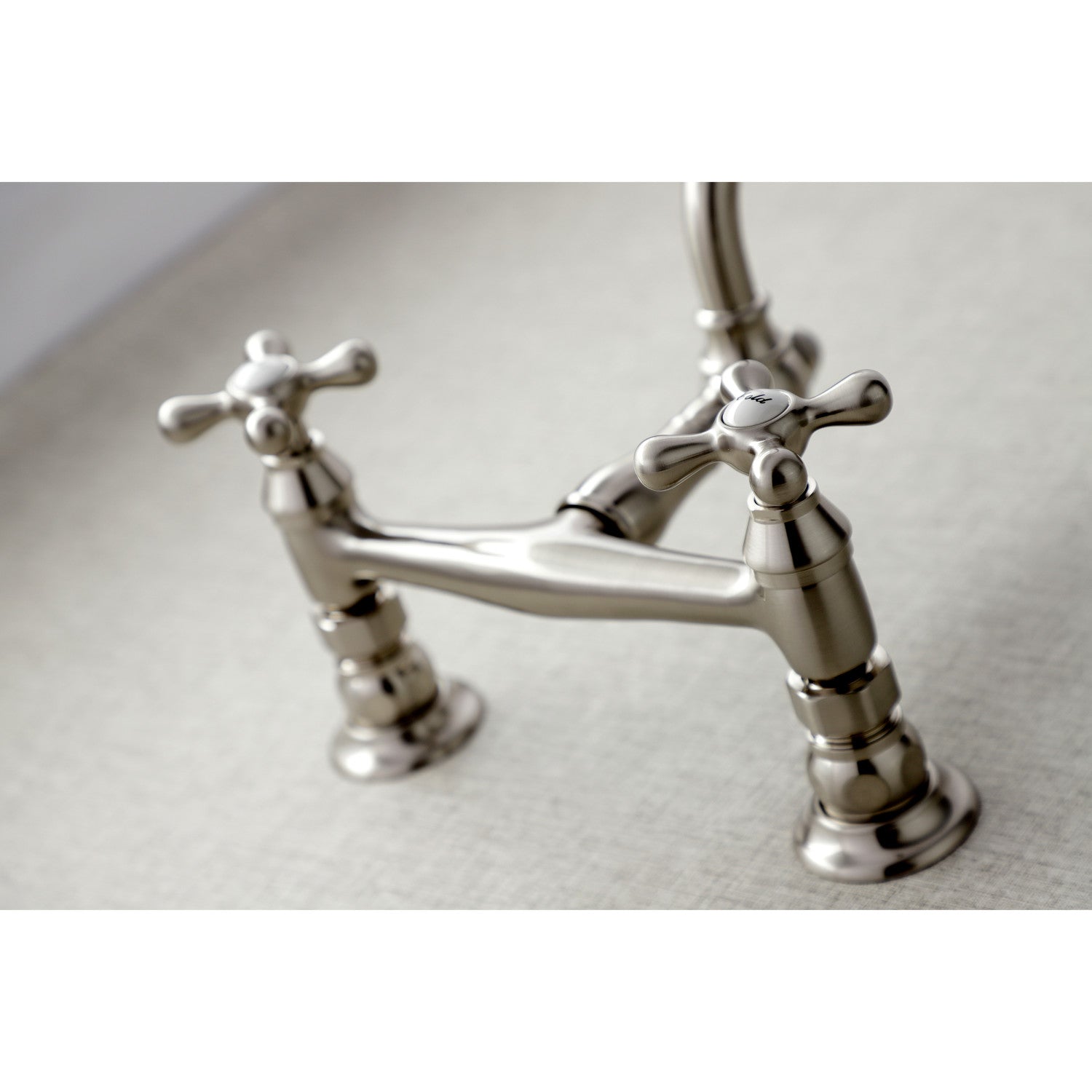 Kingston Brass KS3248AX brushed nickel  bathroom faucet handles close up on a light background
