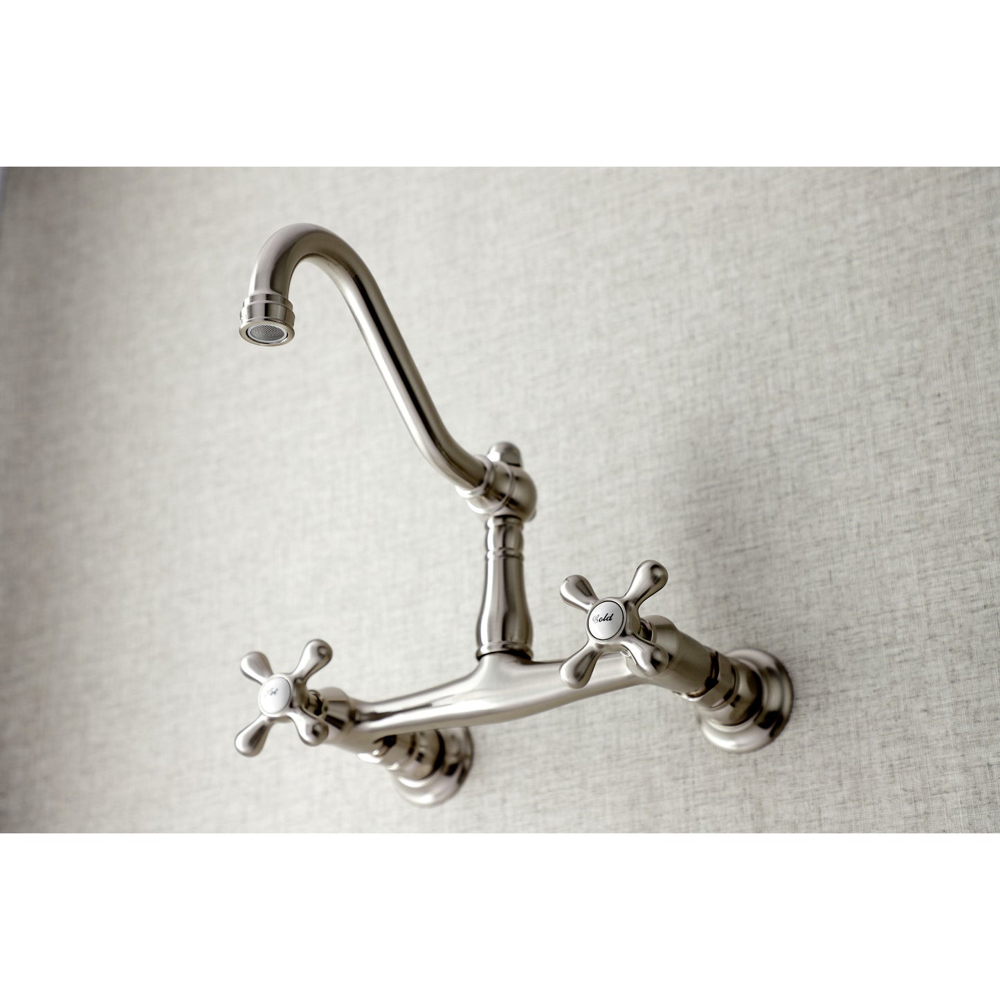 Kingston Brass KS3248AX brushed nickel wall-mounted bathroom faucet on a light gray background