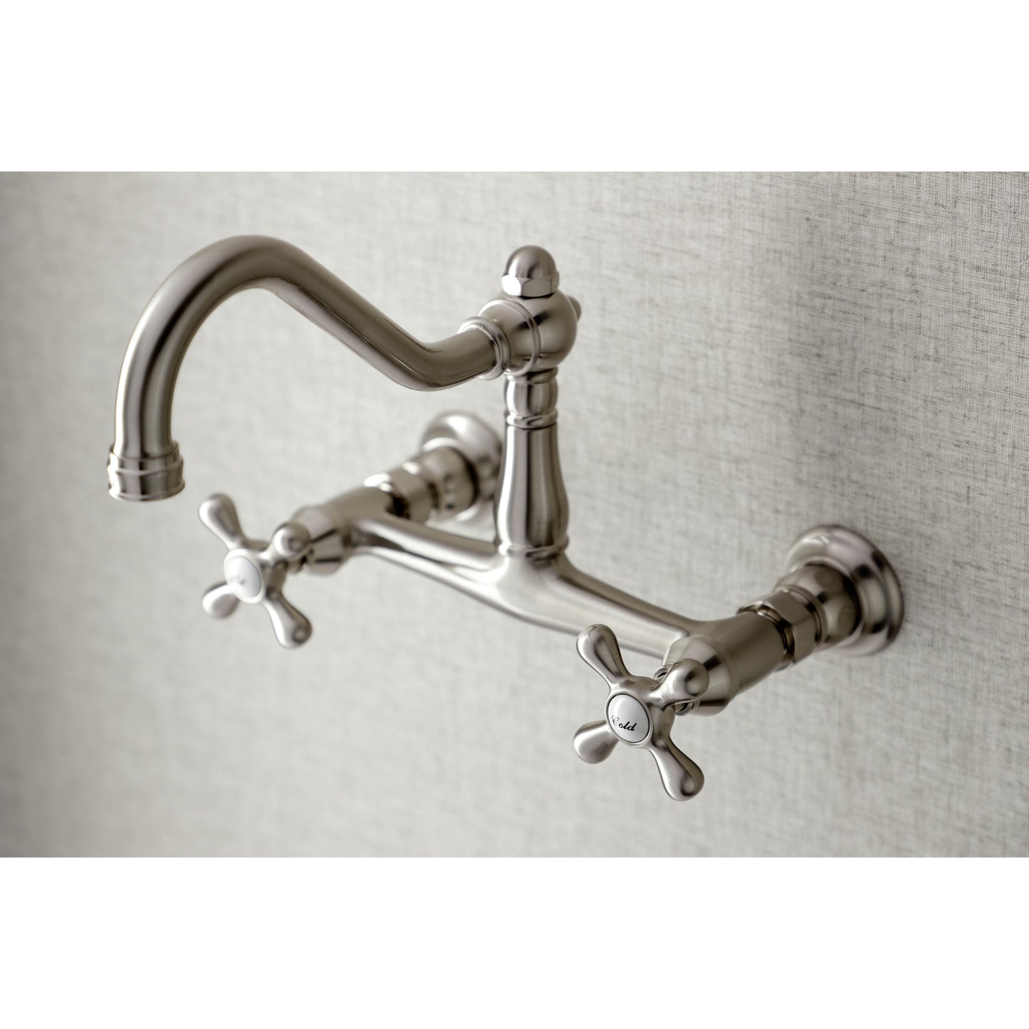Kingston Brass KS3248AX brushed nickel  bathroom bridge faucet mounted on a gray wall