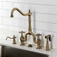 Kingston Brass KS7753AXBS Antique Brass kitchen faucet set against a white tiled wall