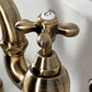 Close-up of a vintage-style Kingston Brass KS7753AXBS Antique Brass kitchen faucet handle