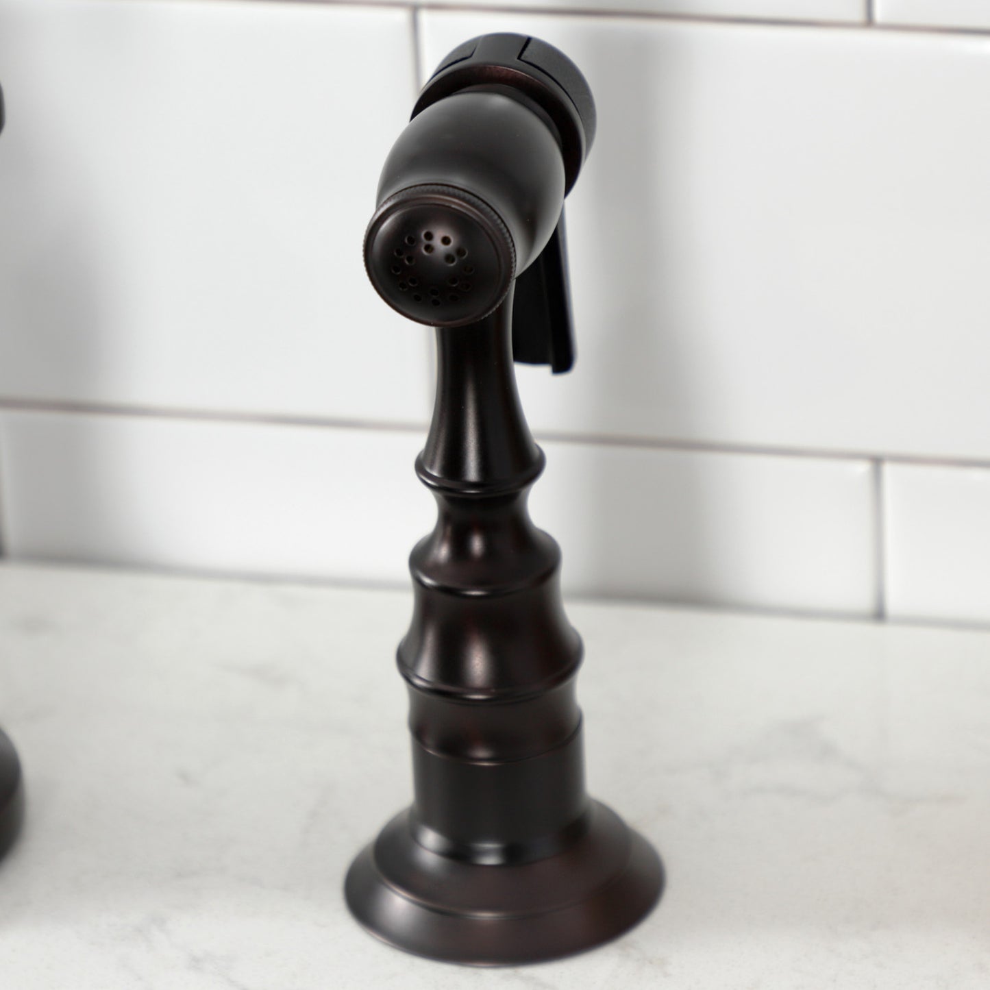 Kingston Brass English Country Deck Mount Bridge Kitchen Faucet side view showing detailed handle design