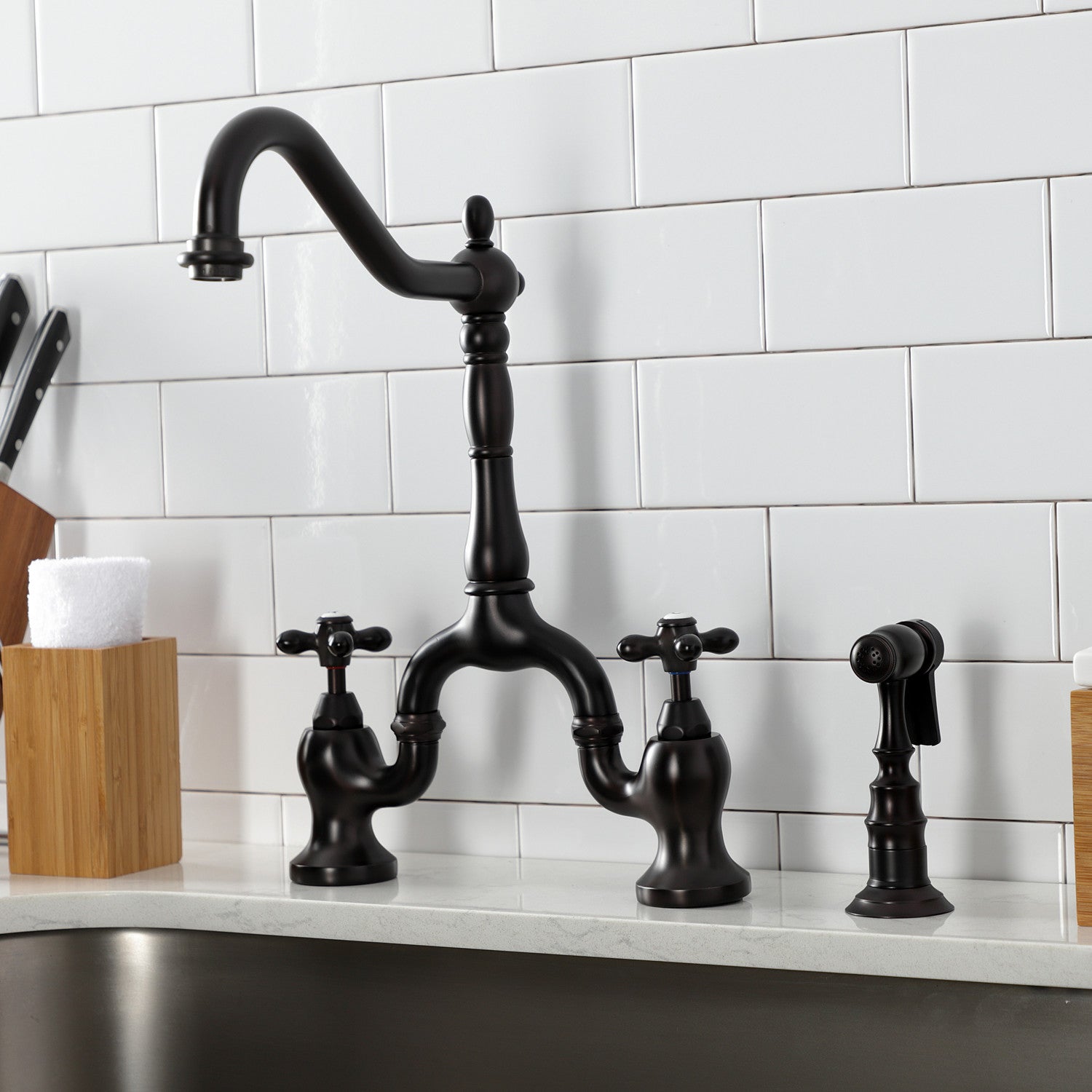 Kingston Brass KS7755AXBS oil rubbed bronze kitchen faucet set against a white tiled wall