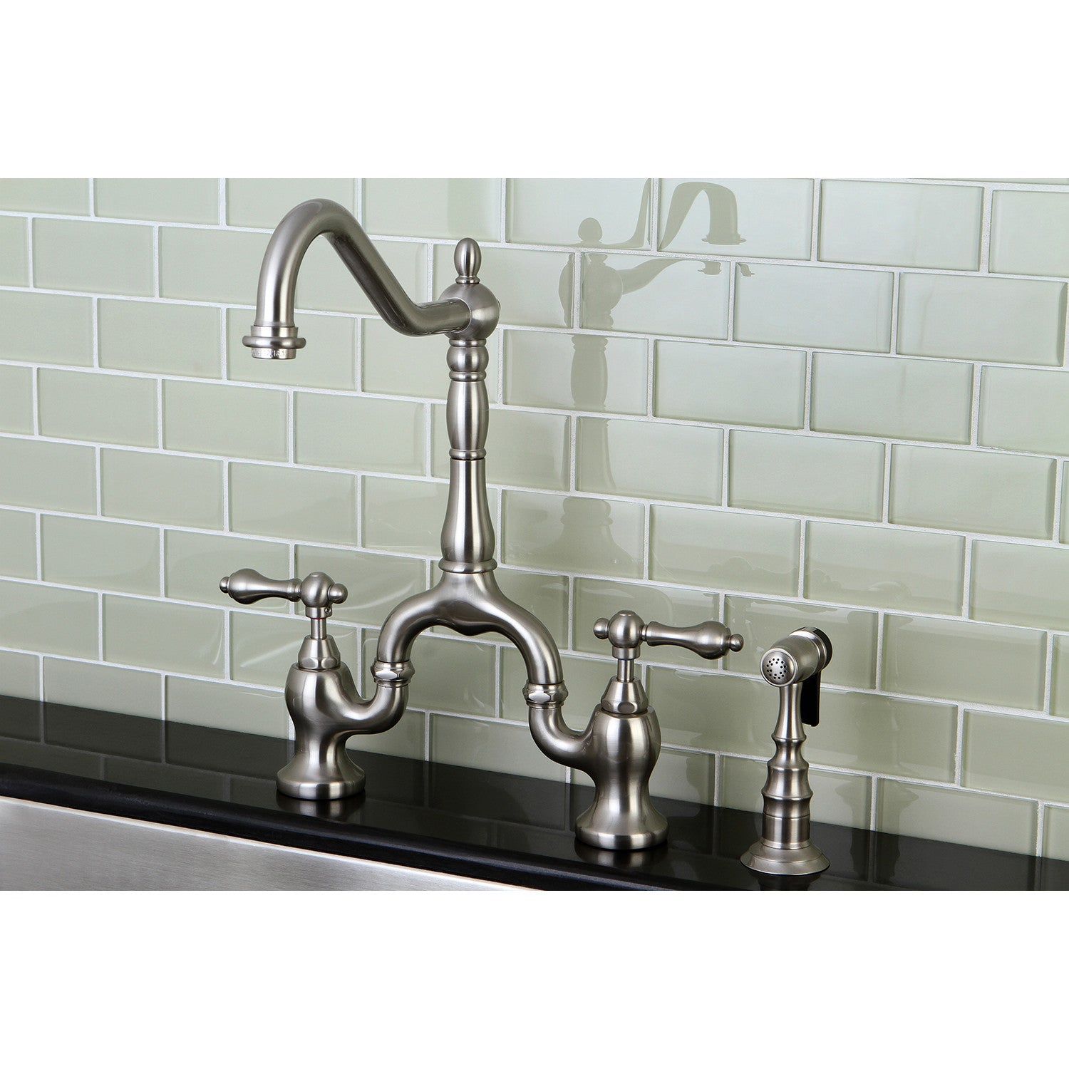 Kingston KS7758ALBS English Country Bridge Kitchen Faucet with Brass Sprayer, Brushed Nickel against a glass subway tile backsplash