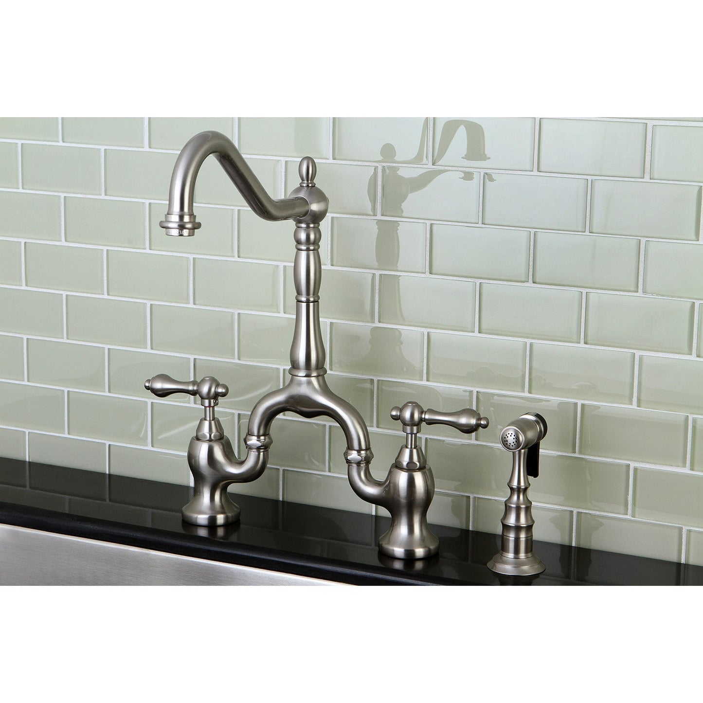 Kingston KS7758ALBS English Country Bridge Kitchen Faucet with Brass Sprayer, Brushed Nickel against a glass subway tile backsplash