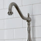Kingston Brass KS7758AXBS brushed nickel faucet detail against a white tiled wall