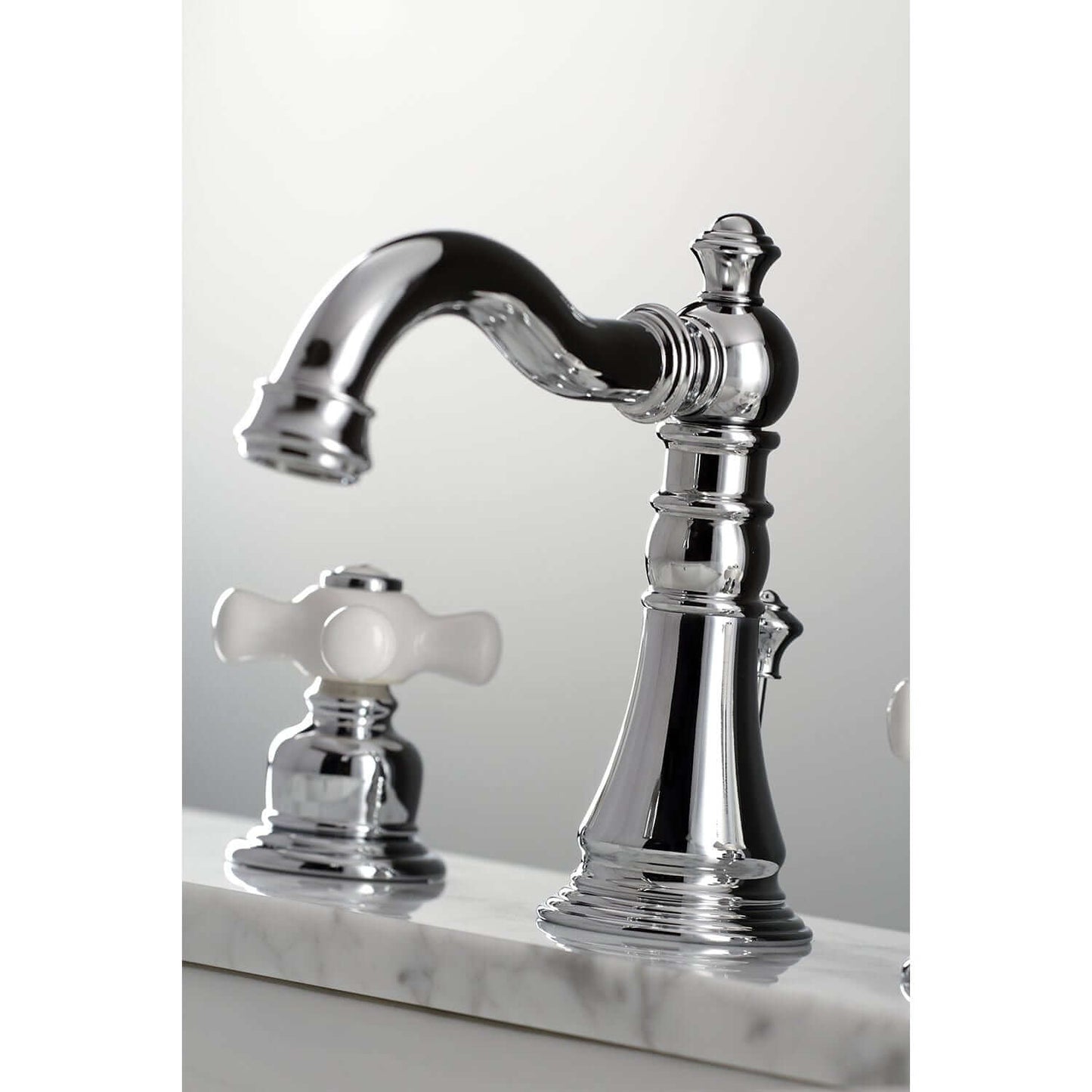 Close-up of KINGSTON Brass American Classic Widespread Bathroom Faucet showcasing elegant design and artistry with a curved spout.