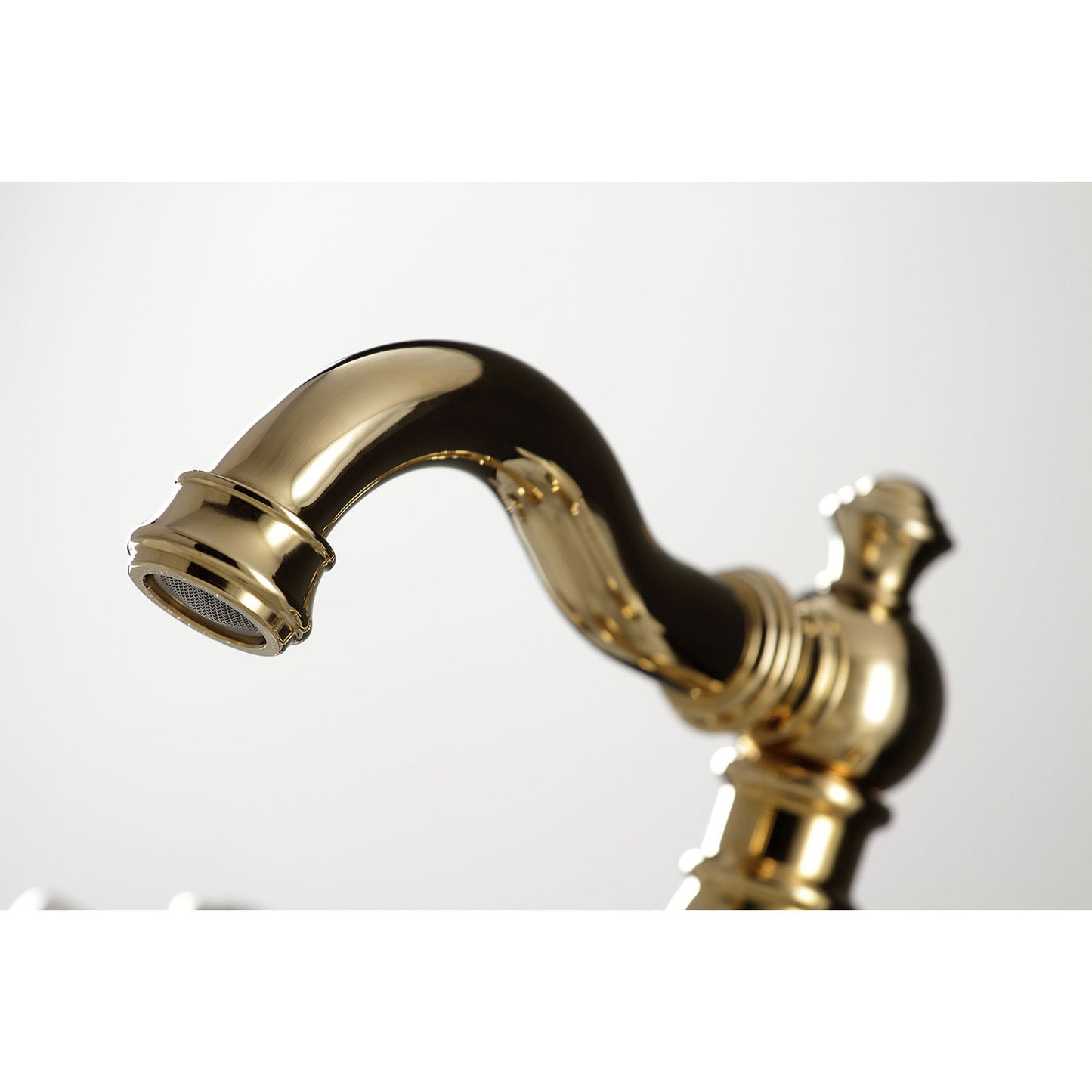 Close-up view of the spout of the KINGSTON Brass American Classic Widespread Bathroom Faucet showcasing its Victorian design.