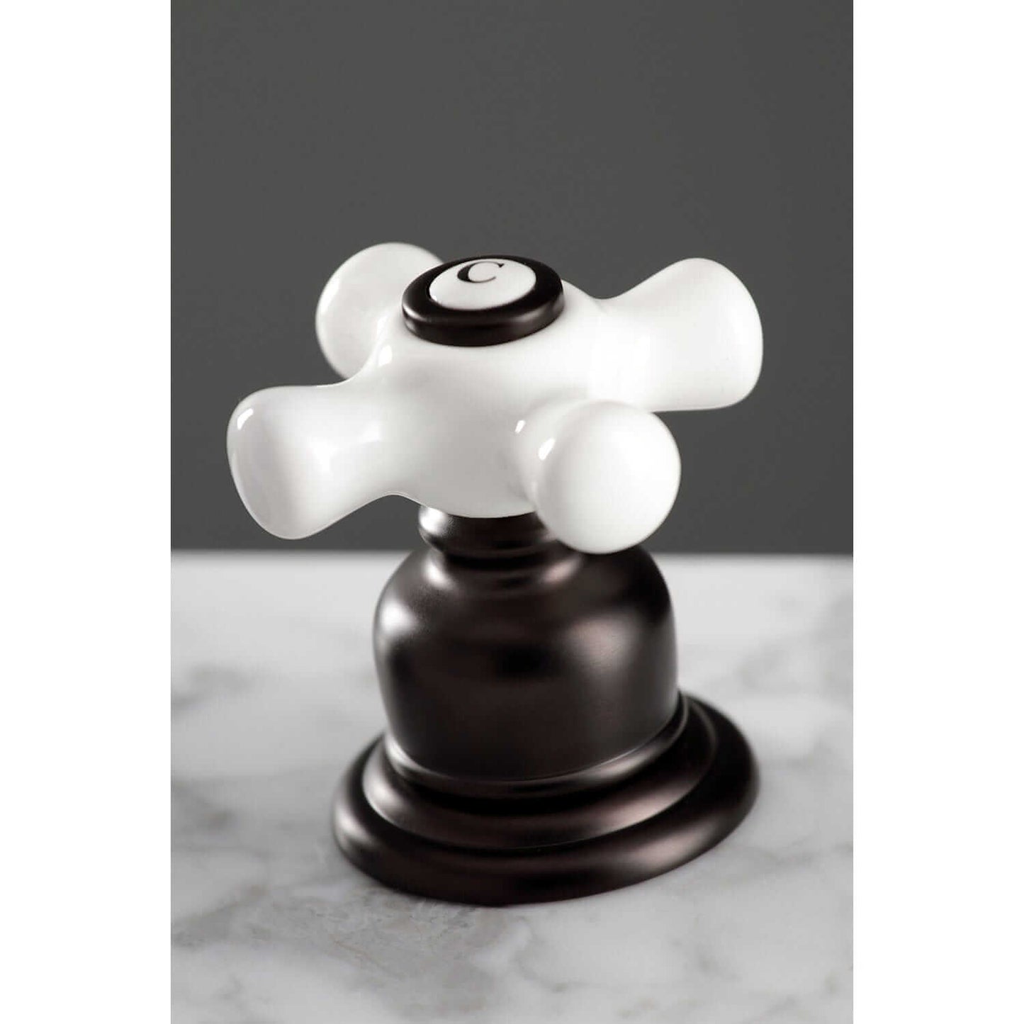 KINGSTON Brass American Classic Widespread Bathroom Faucet top view of elegant white handle with dark base