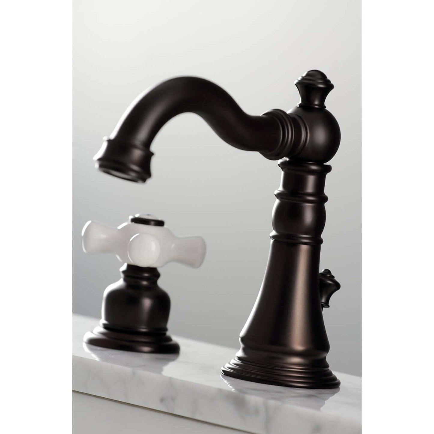 Close-up of KINGSTON Brass American Classic Widespread Bathroom Faucet with elegant dark finish and white handle