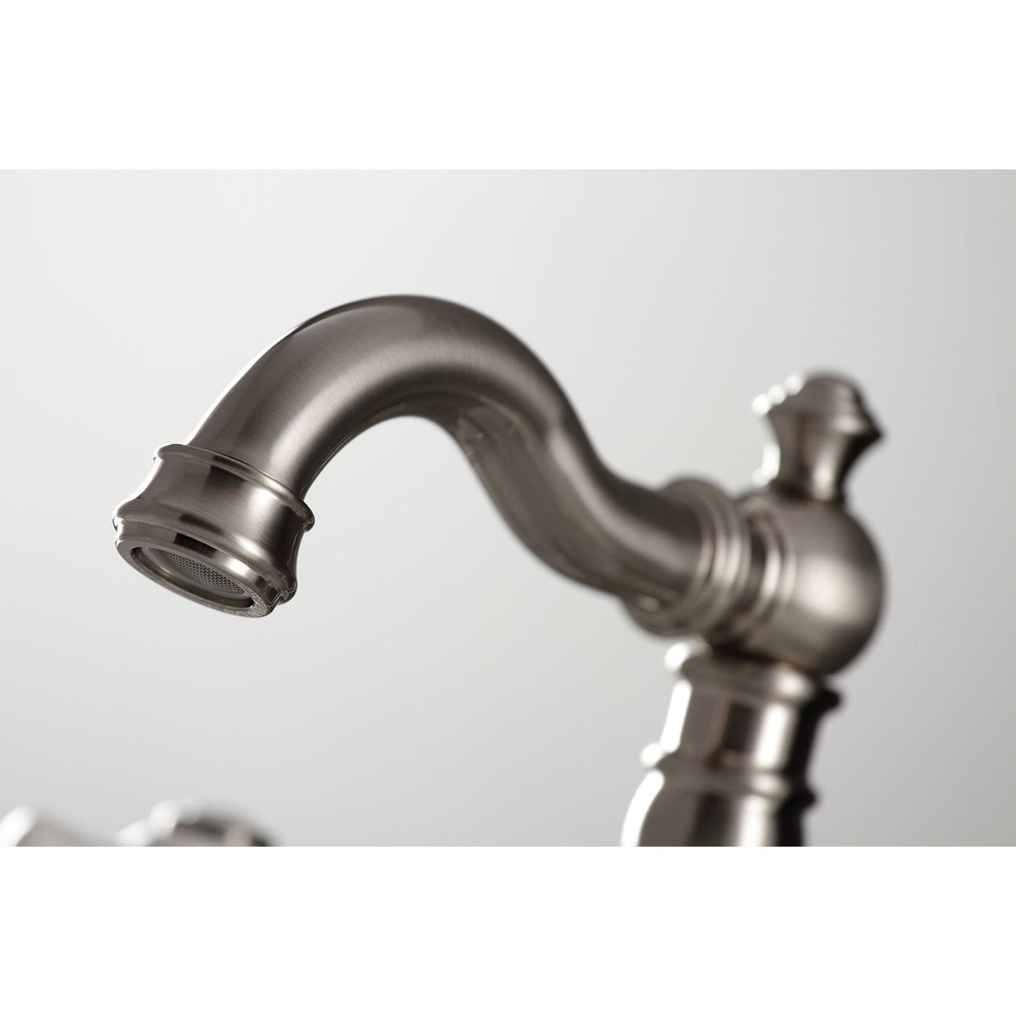 Close-up view of KINGSTON Brass American Classic Widespread Bathroom Faucet spout showcasing detailed craftsmanship.