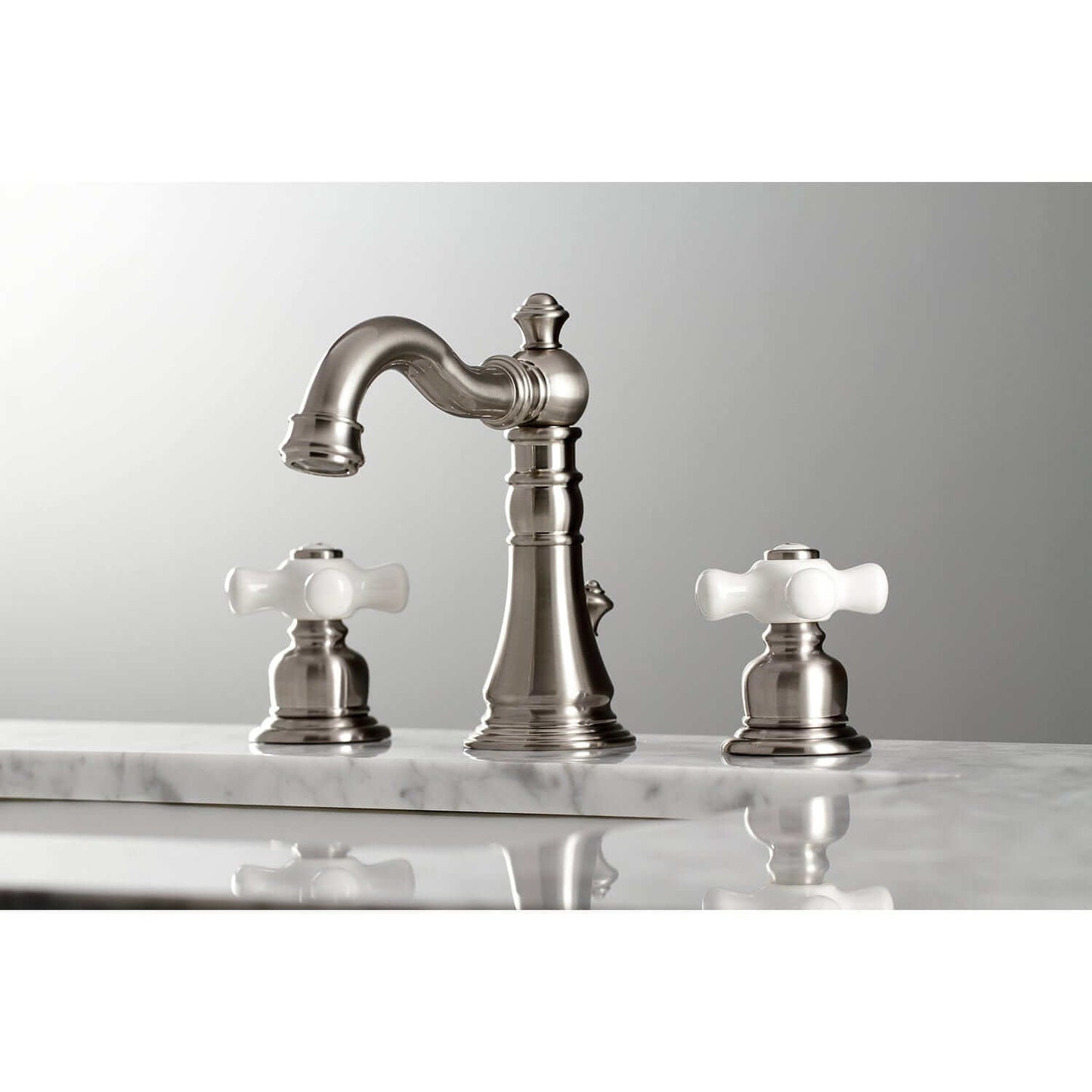 KINGSTON Brass American Classic Widespread Bathroom Faucet right side view with white lever handles on marble countertop.
