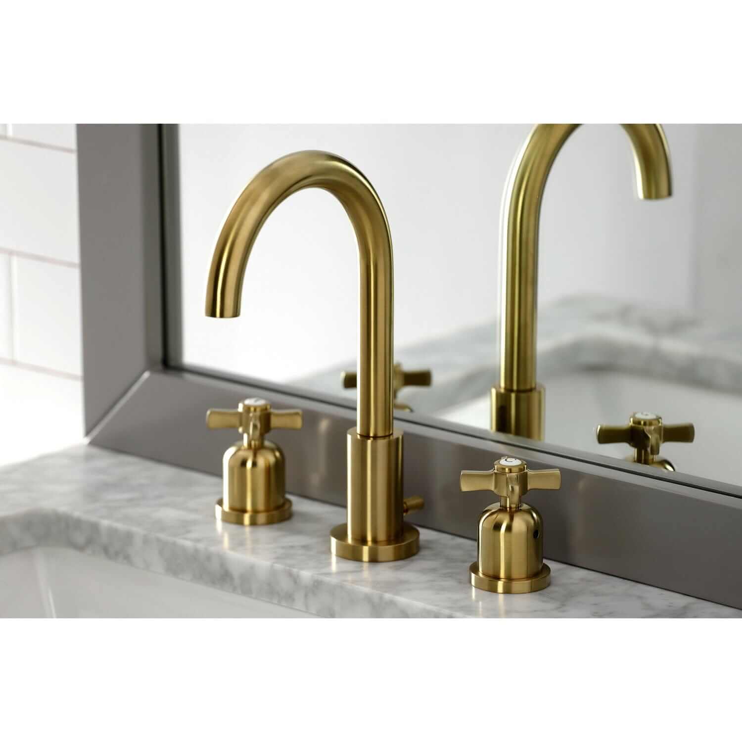 Close up Lifestyle image of Millennium widespread faucet in neutral bathroom in brushed brass finish