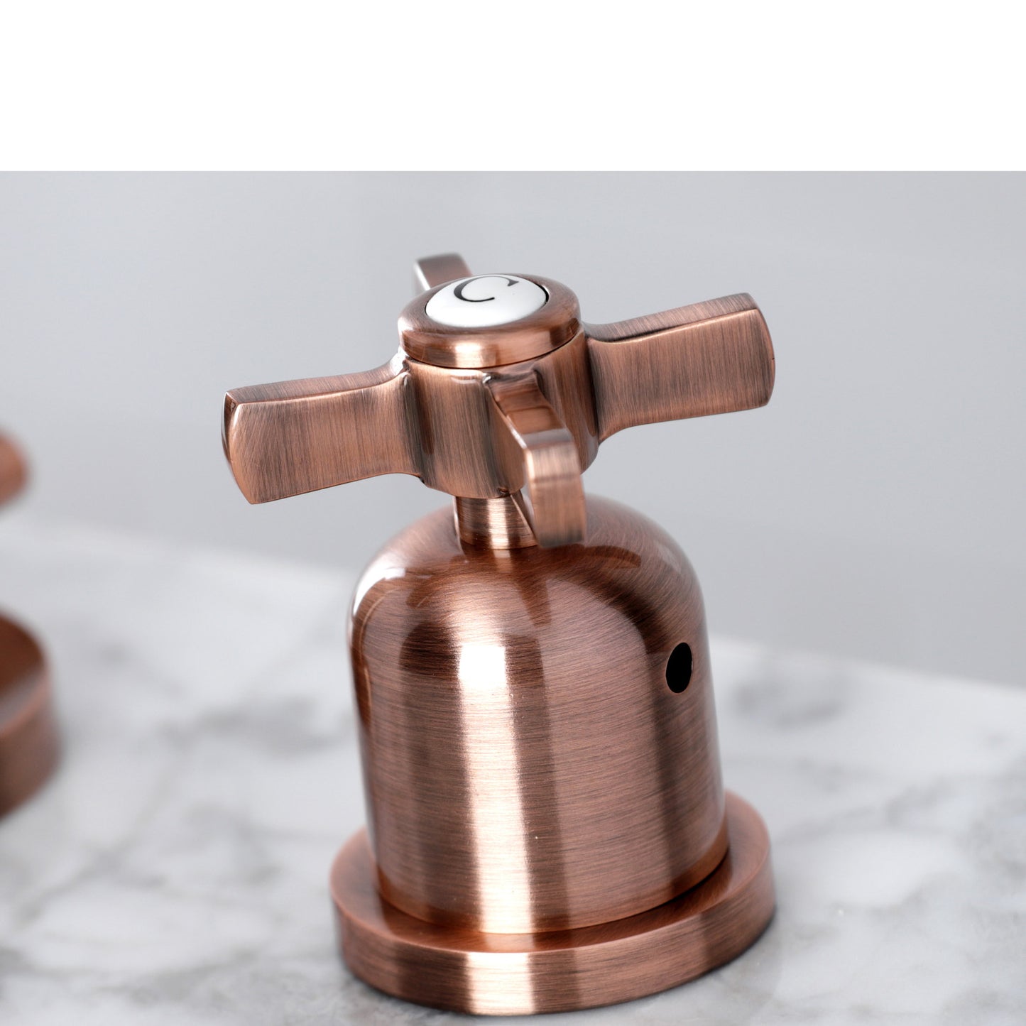 Faucet handle detail for Millennium widespread bathroom faucet in antique copper finish