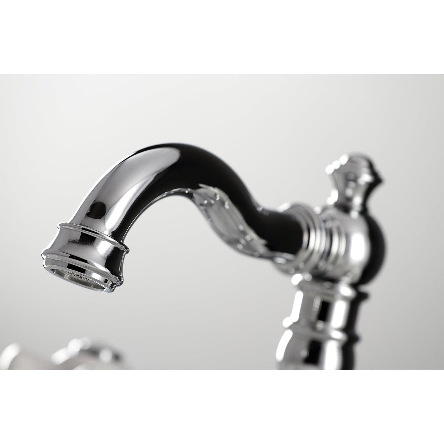 Detail of the spout on the KINGSTON Brass American Classic Widespread Bathroom Faucet showcasing Victorian design.