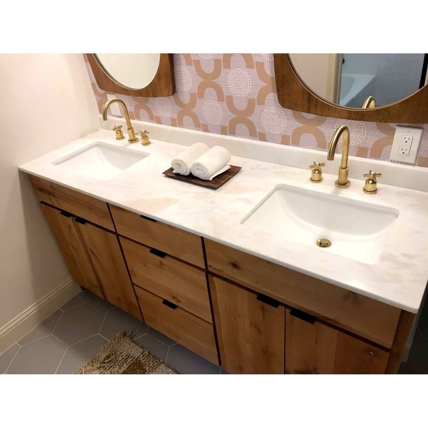 Top down view of bathroom remodel featuring Millennium widespread faucet in Brushed Brass