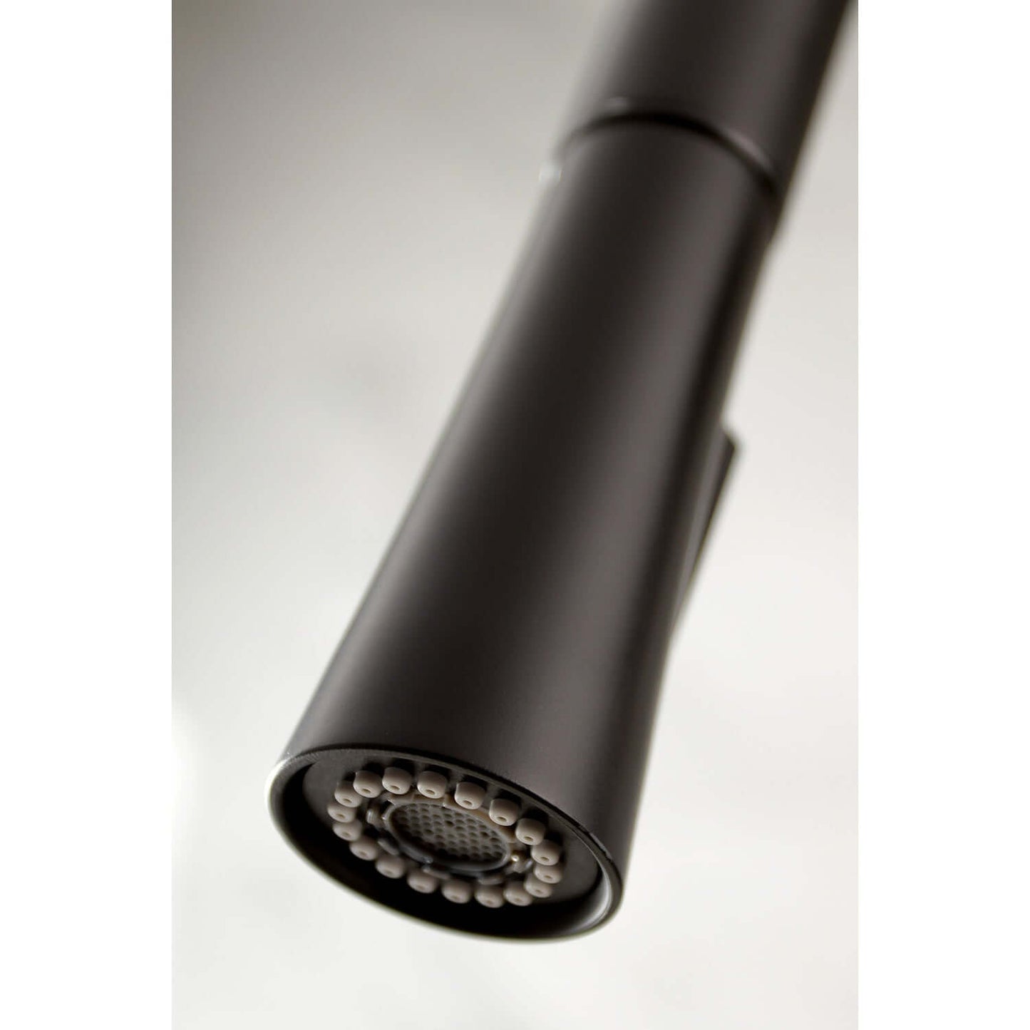 Close-up view of the spray nozzle of the Kingston Brass Single-Handle Pull-Down Kitchen Faucet - LS862XDL-P.
