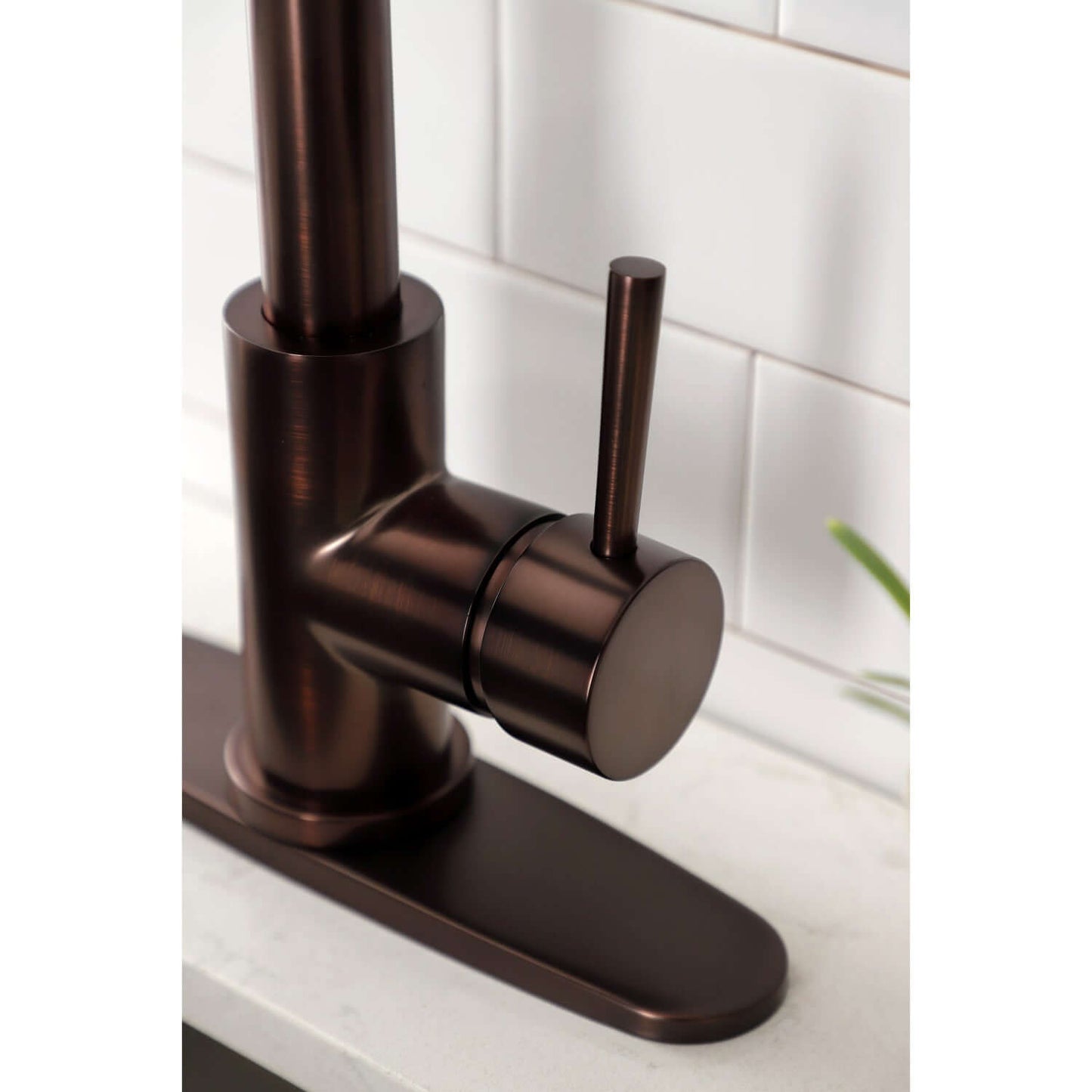 Close up of handle and deck plate for Kingston Brass LS8625DL single-handle oil rubbed bronze kitchen faucet 