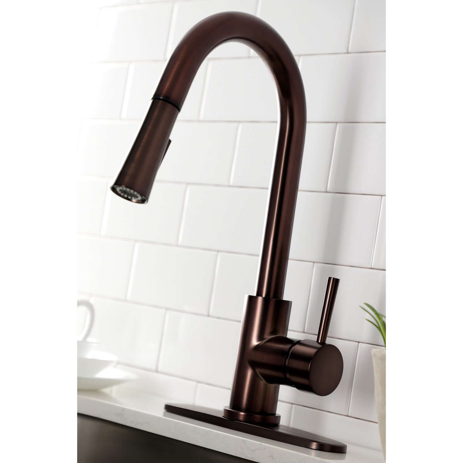 Close up angle of Kingston Brass LS8625DL single-handle oil rubbed bronze kitchen faucet installed with deck plate