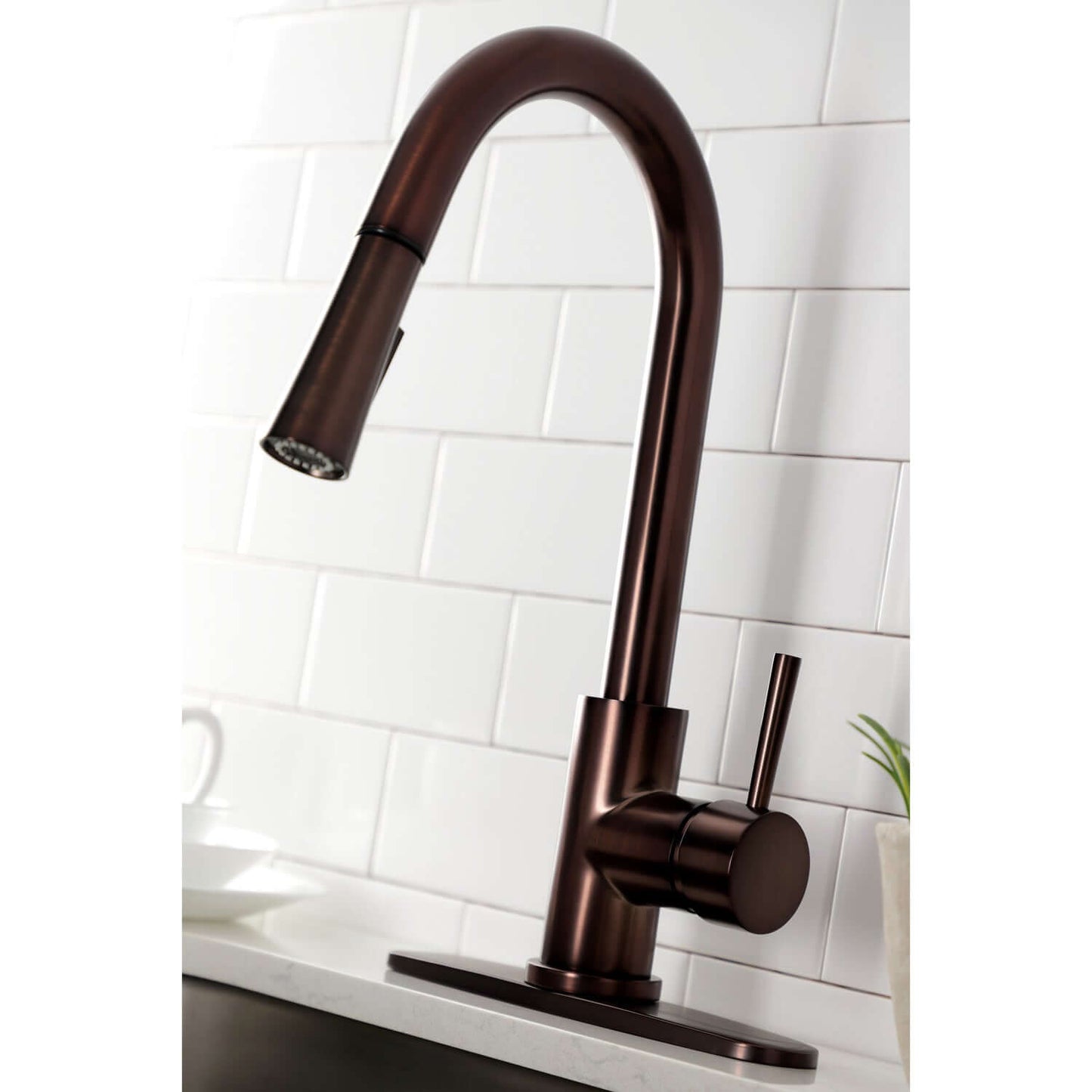 Close up angle of Kingston Brass LS8625DL single-handle oil rubbed bronze kitchen faucet installed with deck plate