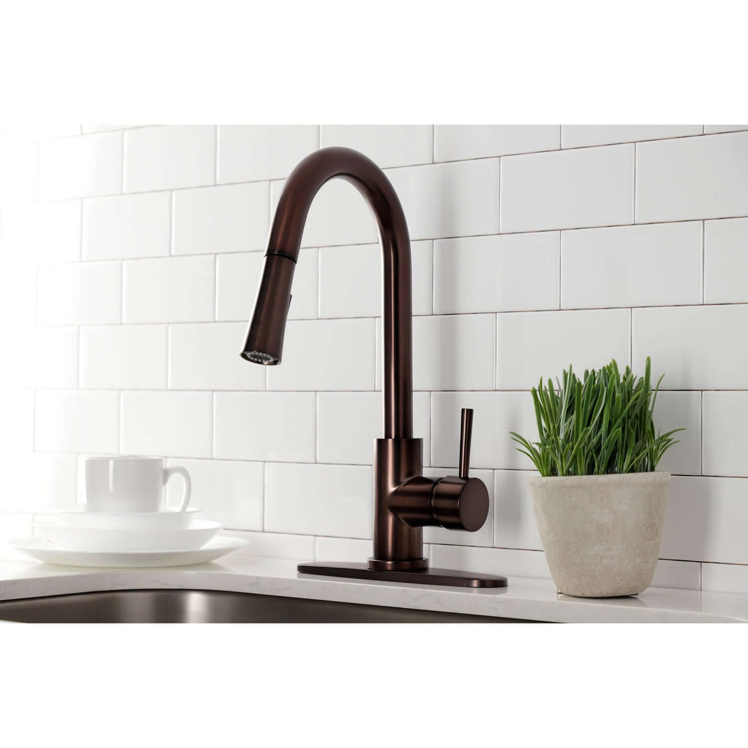 Close up of Kingston Brass LS8625DL single-handle oil rubbed bronze kitchen faucet installed with deck plate