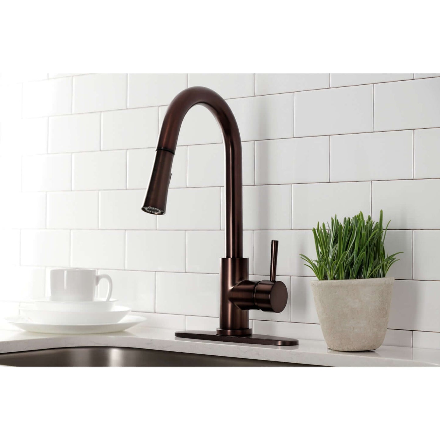 Close up of Kingston Brass LS8625DL single-handle oil rubbed bronze kitchen faucet installed with deck plate