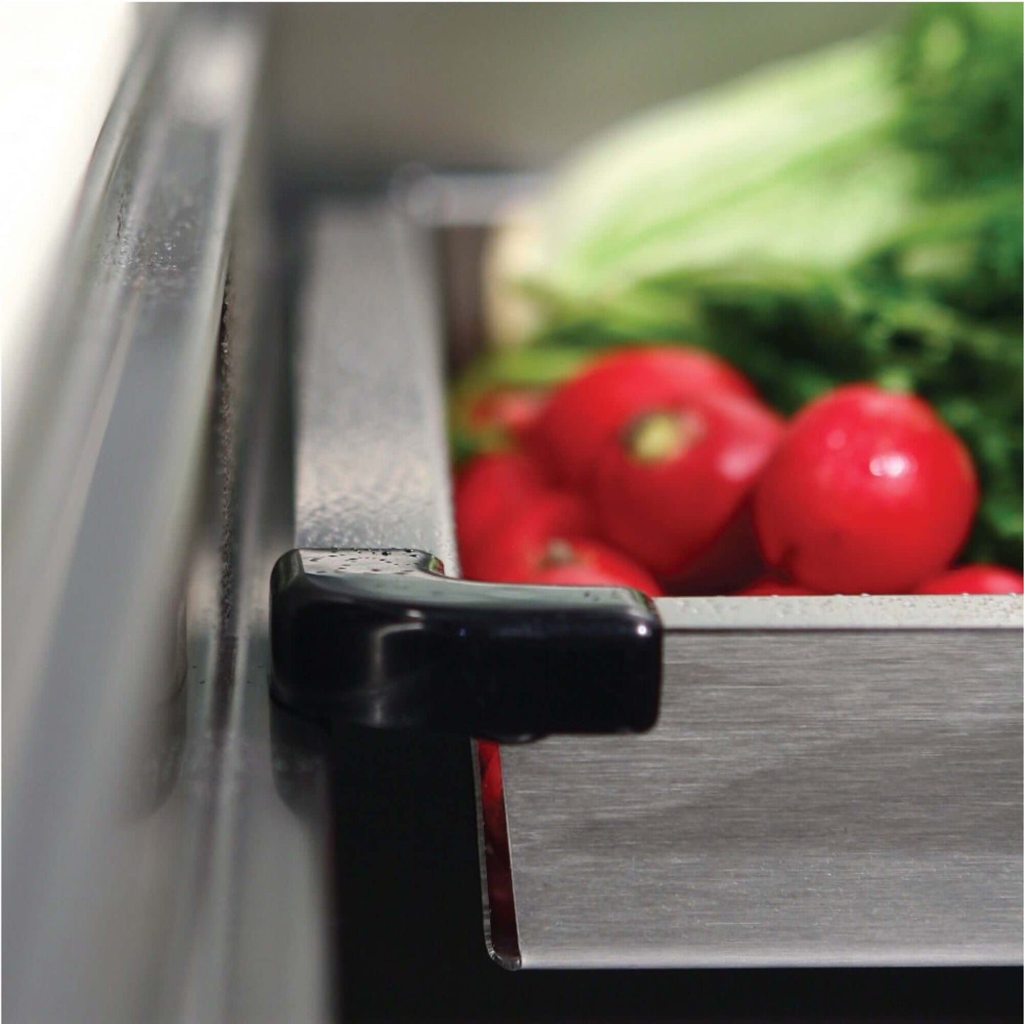 HOUZER NOVUS 26" Stainless Steel Undermount Kitchen Sink, NVS-2600 showcasing a sliding accessory with fresh vegetables.