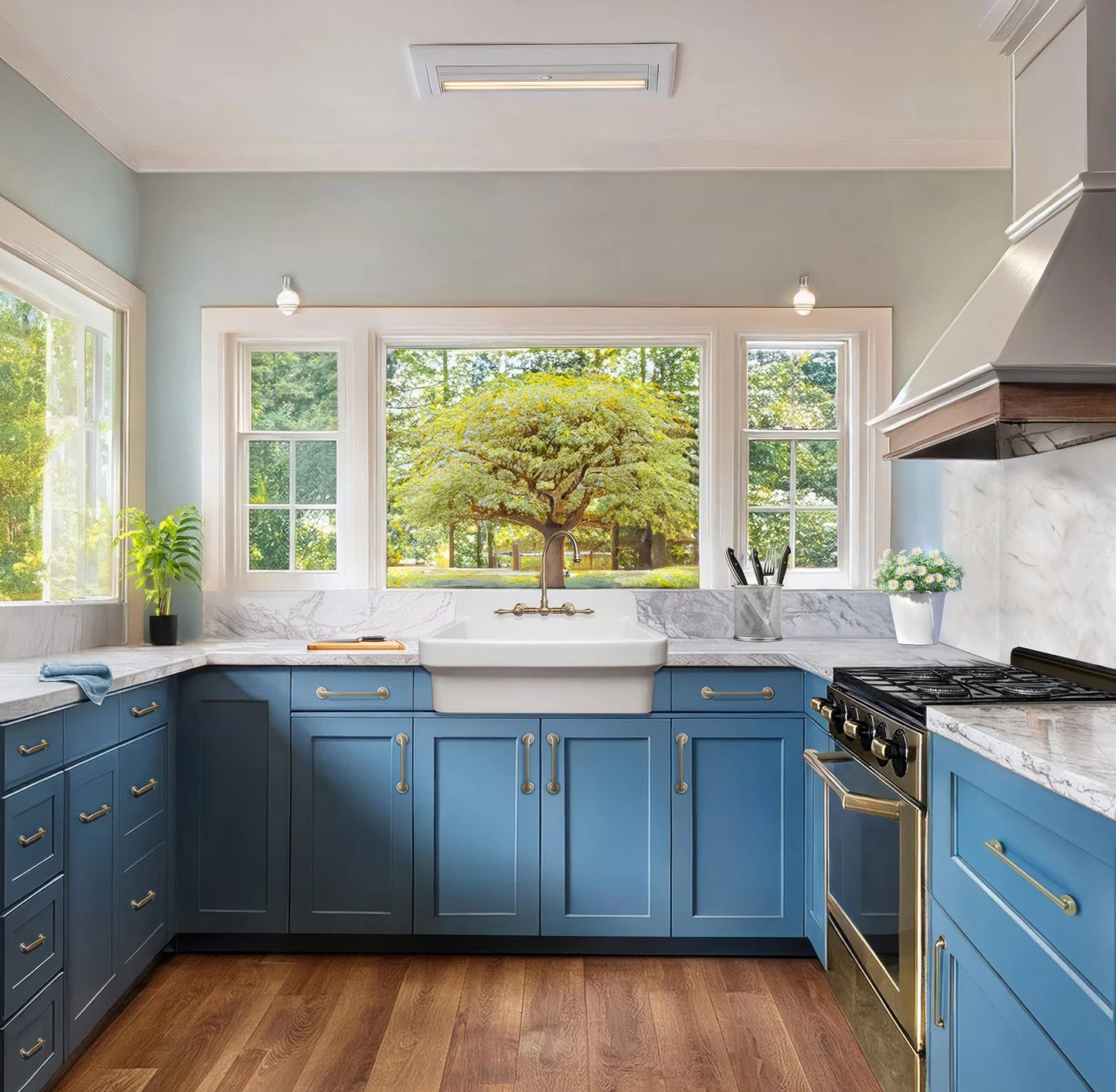 Modern kitchen with blue cabinets, white countertops, and a large window view.