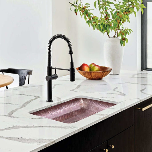 Nantucket Sinks 17" Hammered Copper Rectangle Bar Sink - REHC-2.5 in modern kitchen with black faucet and marble countertop.