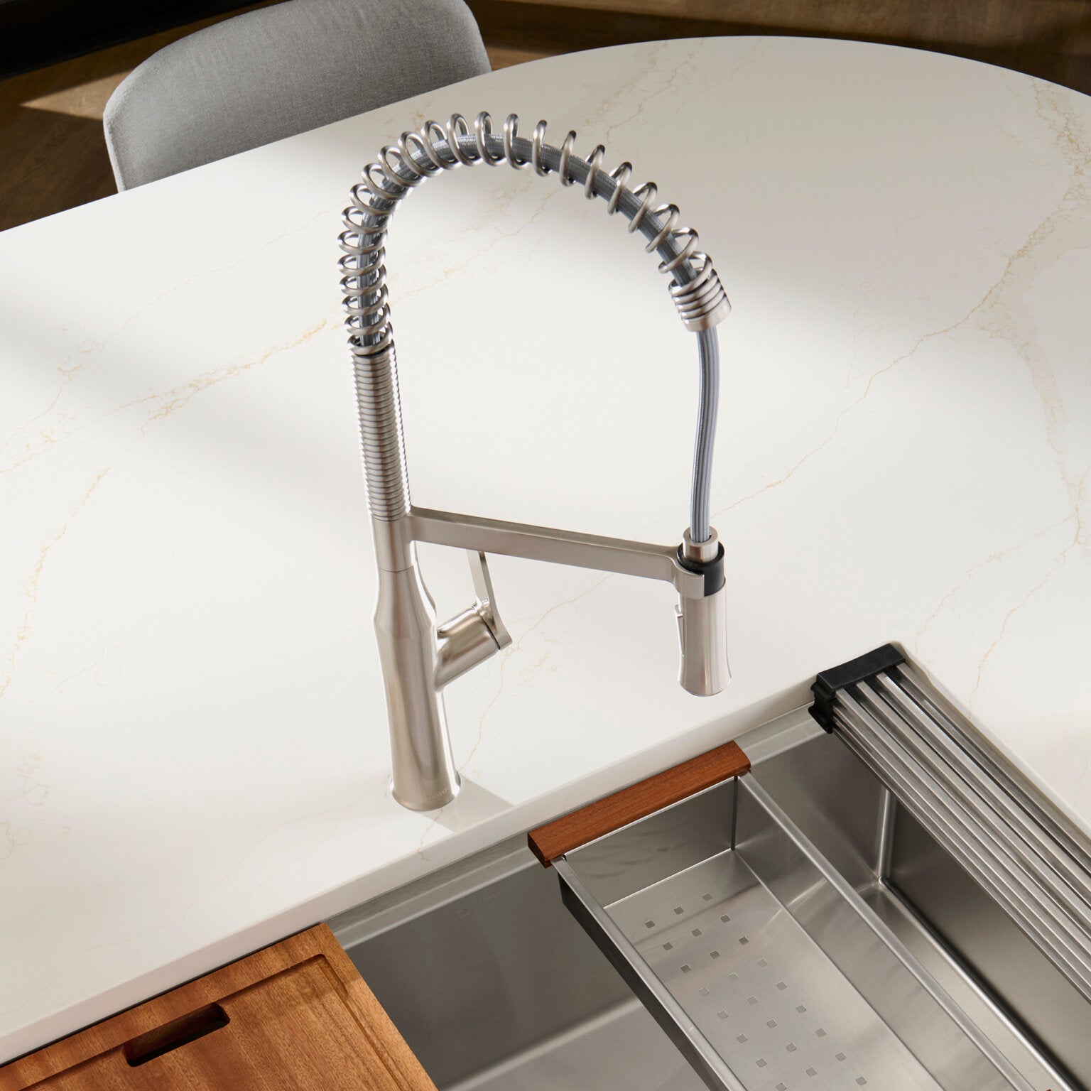 Ruvati RVF1233 Bianca Single-Handle Tall High-Arc Commercial Kitchen Faucet with Pre-Rinse Sprayer on a countertop.