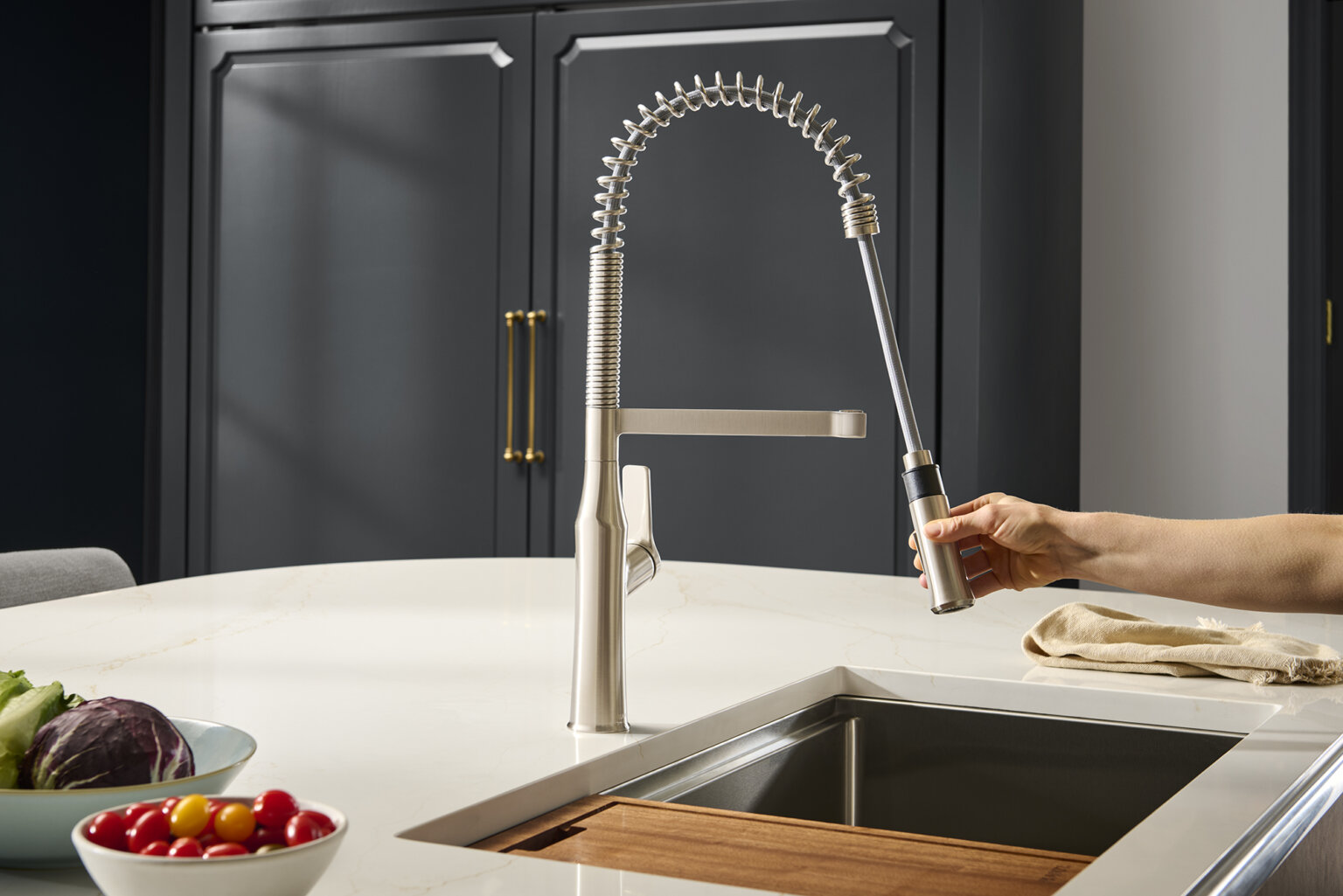 Ruvati RVF1233 Bianca Single-Handle Tall High-Arc Commercial Kitchen Faucet with Pre-Rinse Sprayer in a modern kitchen.