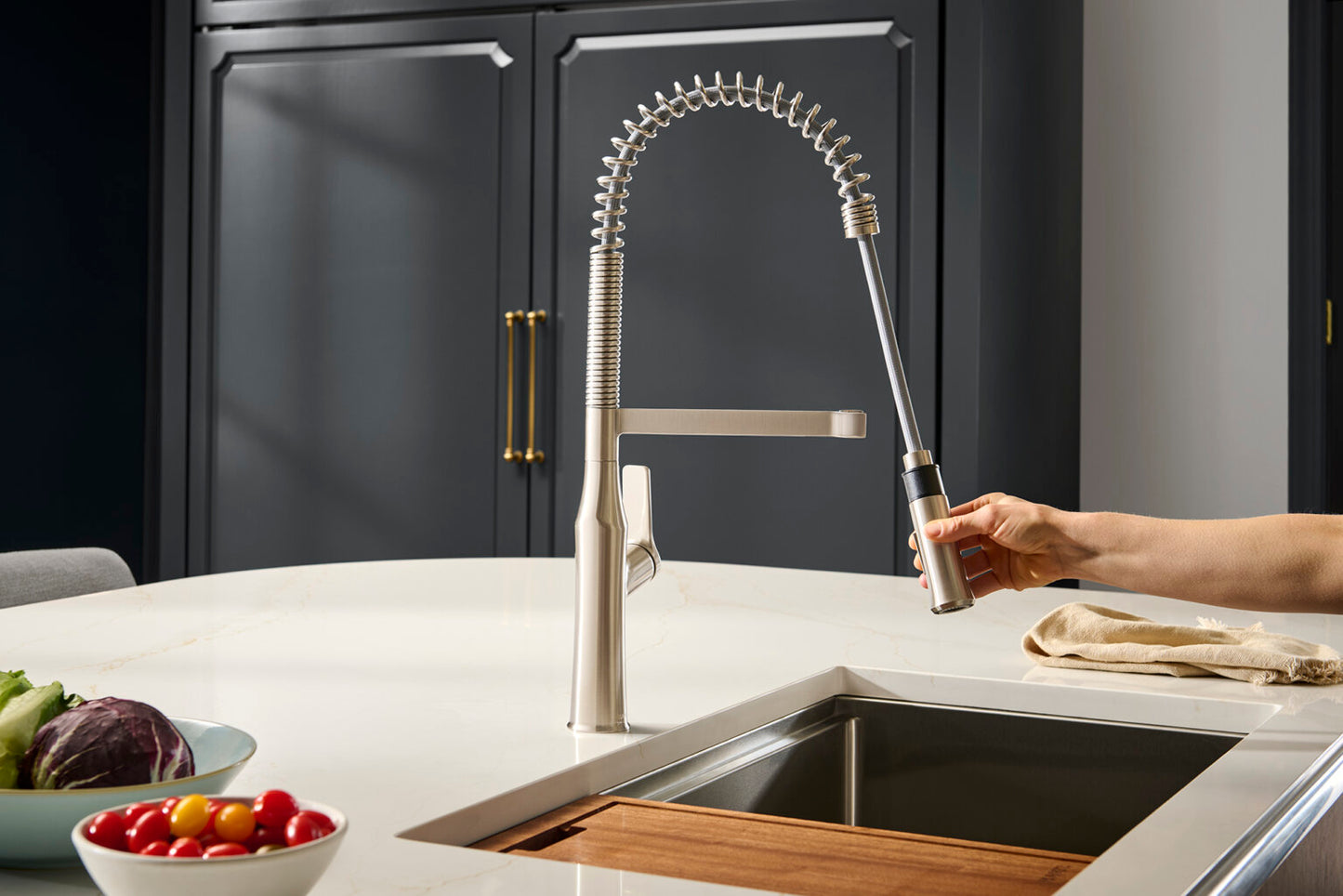 Ruvati RVF1233 Bianca Single-Handle Tall High-Arc Commercial Kitchen Faucet with Pre-Rinse Sprayer in a modern kitchen.