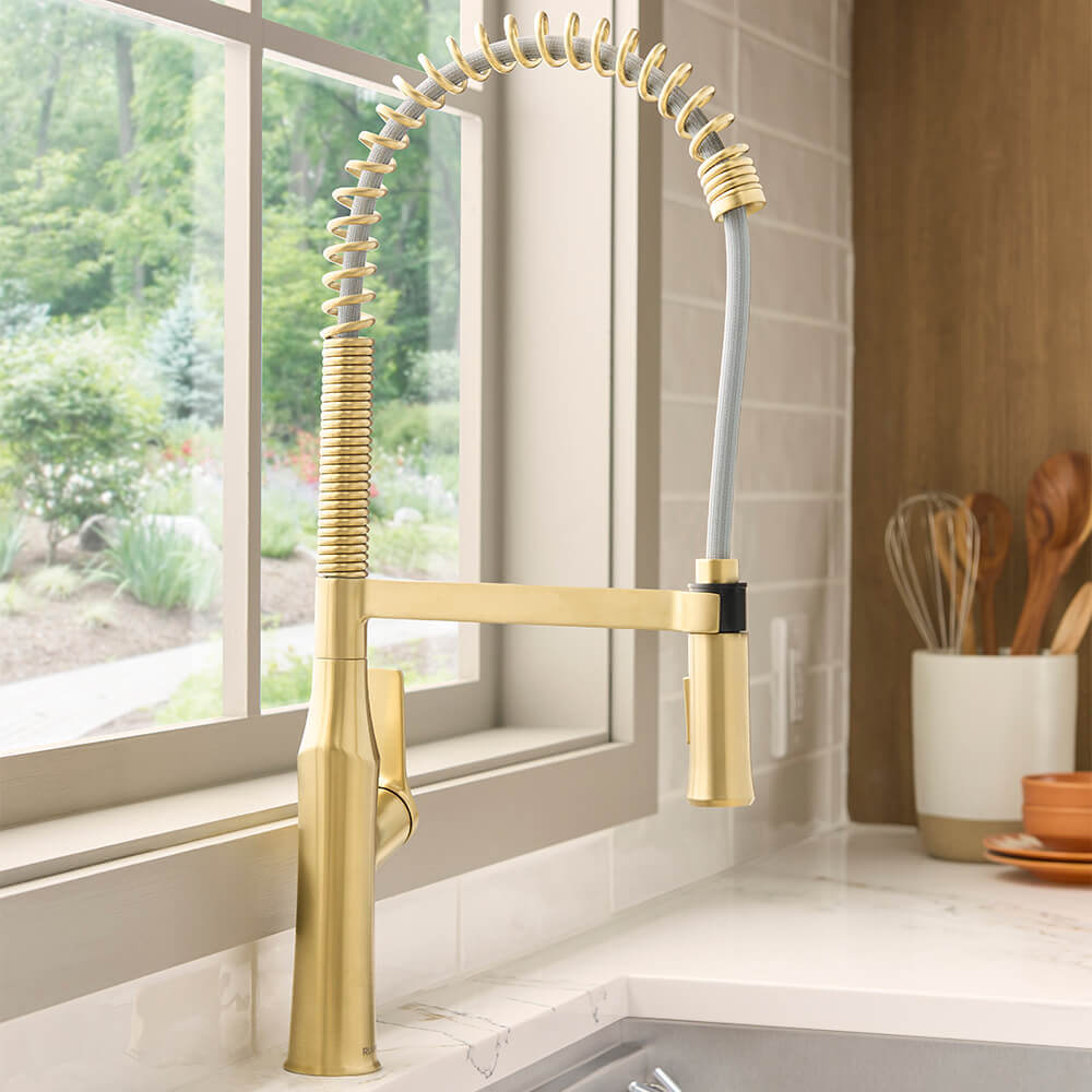 Ruvati RVF1233 Bianca Single-Handle Tall High-Arc Commercial Kitchen Faucet with Pre-Rinse Sprayer in Brushed Gold finish.