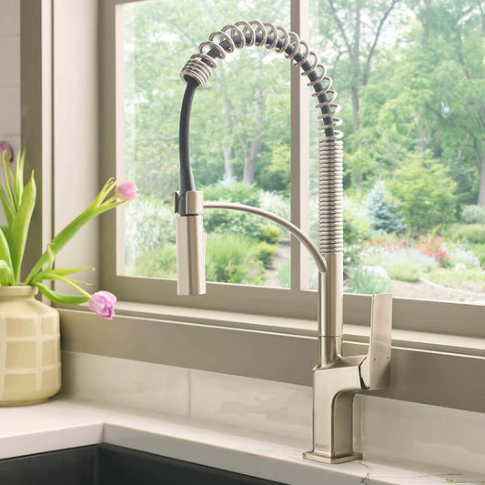 Ruvati RVF1236 Seneca Single-Handle Spring Pull-Down Kitchen Faucet with Pre-Rinse Sprayer in a modern kitchen setting.