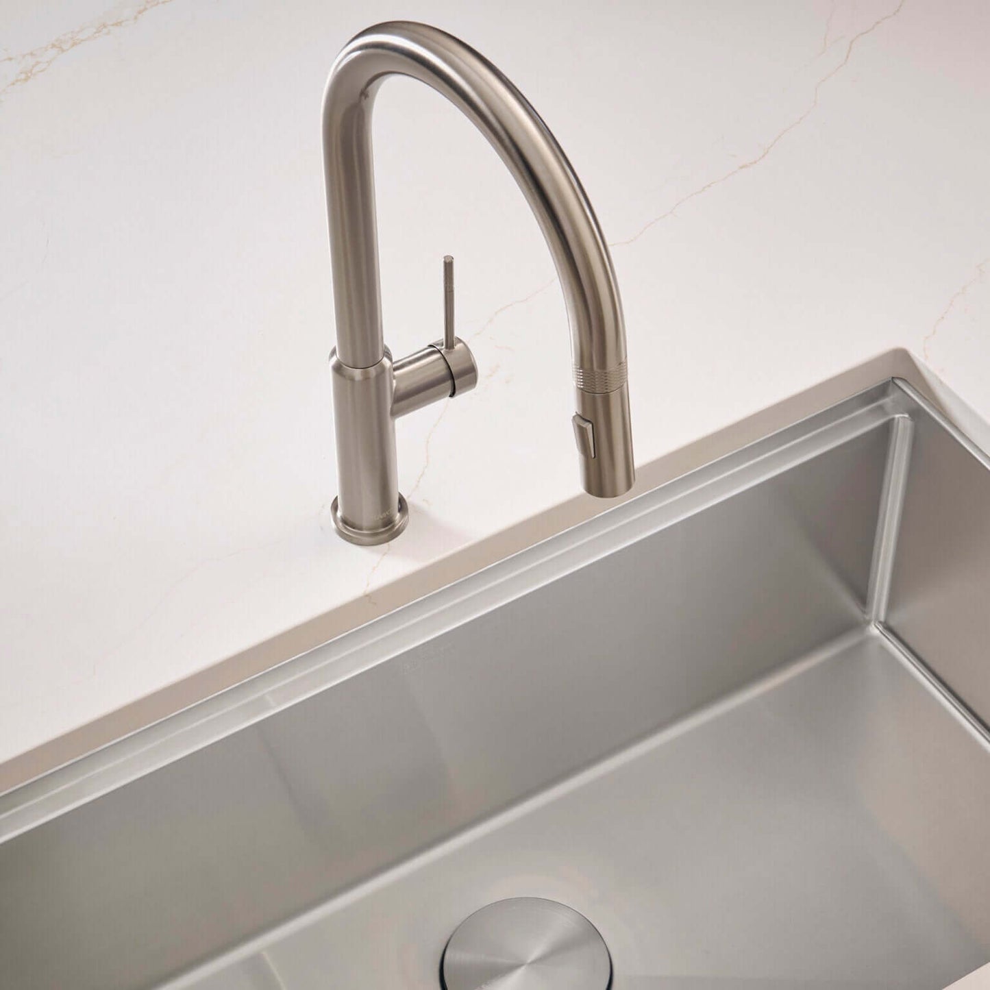 Ruvati RVF1237 Vestia Single-Handle Pull-Down Kitchen Faucet with Knurl Detail over a stainless-steel sink.