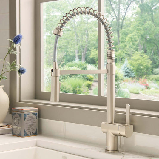 Ruvati RVF1243 Seneca Single-Handle Pull-Down Pull-Out Spring Kitchen Faucet in Stainless Steel finish by a window.